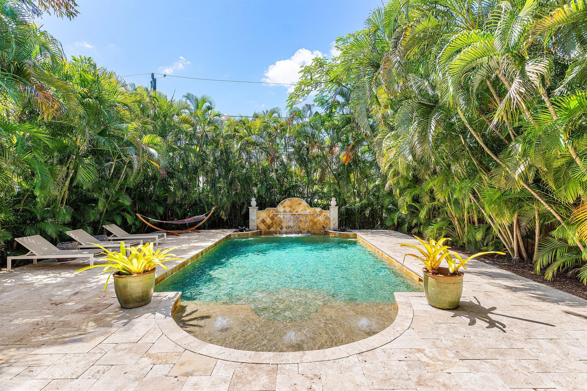 Welcome to Wilton Manors living at its finest! This beautifully updated 3-bedroom, 2.5-bathroom residence offers the perfect blend of comfort, style, and convenience.Step outside to your private oasis featuring a custom PebbleTec heated and chilled pool with a stunning Turkish marble deck, outdoor heated shower, hot tub, and a large covered patio ideal for entertaining or relaxing year-round. Mature landscaping creates total privacy in the backyard retreat.Inside, enjoy peace of mind with a whole-house carbon water filtration system and the convenience of a true turn-key option. The master suite includes a private water closet, while easily accessible attic space provides ample room for storage.