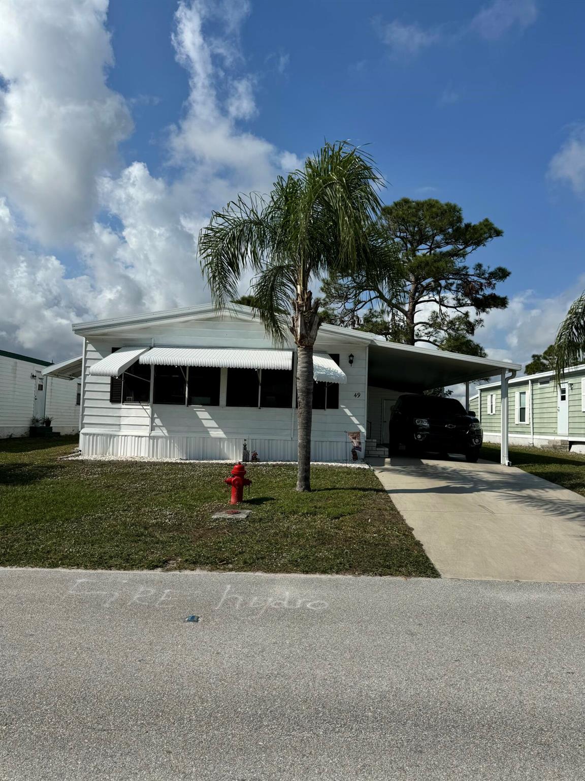 Lovely golf course view home. 2 bedroom 2 bath room home in the desirable 55+Spanish Lakes Country Club Village community. Newer A/C 2023 4 ton with heat pump. Home has an open kitchen, built in shelves in dining area. Laminate and carpet floors. Front room with lots of natural light. Washer and Dryer 2025. Home is being sold furnished. Brand new TV 2025 in living room is conveying with home. Screened in patio overlooking the 2nd hole. Great spot for morning coffee or evening cocktails. Lawn care and trash removal included in lot rent. 2 pools, tennis, pickleball, bocceball, shuffle board. club house and much more.