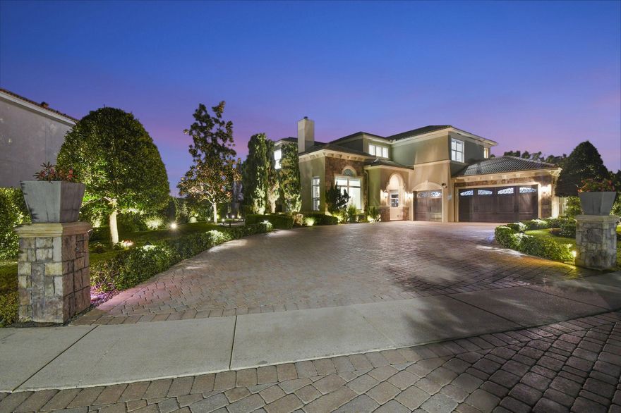 Located in the prestigious Estate Section of Cobblestone Creek, this meticulously maintained, fully renovated residence showcases custom, high-end finishes throughout and sits on a rare premium oversized lot. Enjoy the longest lake view in the community and the largest driveway Cobblestone Creek has to offer, creating exceptional curb appeal and privacy.
The home offers flexible living with up to five bedrooms. A downstairs office/den features a removable custom wine storage system, allowing for easy conversion to a bedroom with closet, while an upstairs office with a barn door can also serve as an additional bedroom.
The expansive primary suite is a private retreat, featuring two walk-in closets with custom California Closet systems, a screened balcony overlooking the lake (See More) The expansive primary suite is a private retreat, featuring two walk-in closets with custom California Closet systems, a screened balcony overlooking the lake, and a fully renovated 2025 spa-style bathroom with porcelain tile, dual floating vanities, a large glass-enclosed shower, freestanding soaking tub, and private water closet.
Recent renovations include a gourmet kitchen appointed with Thermador appliances, microwave and convection oven combo, induction cooktop, vented hood, porcelain countertops, and a built-in Miele coffee system. Additional highlights include marble flooring, elegant window treatments, soaring ceilings, crown molding, a real wood-burning fireplace, impact windows, iron staircase, second-floor wood flooring, and a custom garage organization system.
Designed for effortless entertaining, the formal dining room features a temperature-controlled wine display accommodating up to 400 bottles, a chandelier lift, and seamless indoor-outdoor flow. The covered patio offers a built-in grill, freeform pool, and serene lake views, all within a fully fenced backyard enhanced by northern-inspired landscaping.