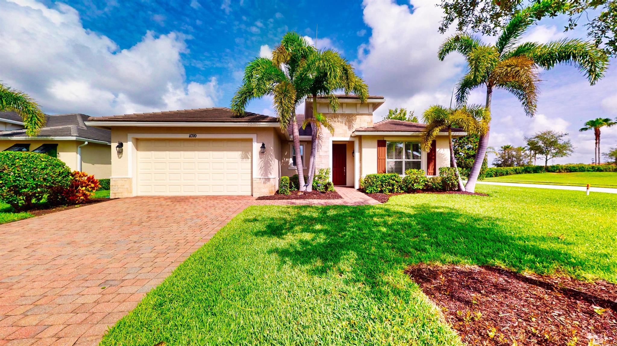 Located on a beautifully landscaped corner lot, this spacious 2-bedroom, 2.5-bath home with a versatile den offers over 2,100 square feet of elegant living in a thoughtfully designed layout. The home welcomes you with a large, open family room featuring soaring ceilings--perfect for entertaining or relaxing in style. The gourmet kitchen is equipped with upgraded 42-inch cabinets, granite countertops, a gas range, and ample storage, seamlessly connecting to the dining and living areas. The expansive master suite is a private retreat with a custom walk-in closet and a well-appointed en-suite bathroom featuring his and hers sinks and a large walk in shower. The split floor plan ensures privacy, with a generous second bedroom offering its own en-suite bath, ideal for guests.