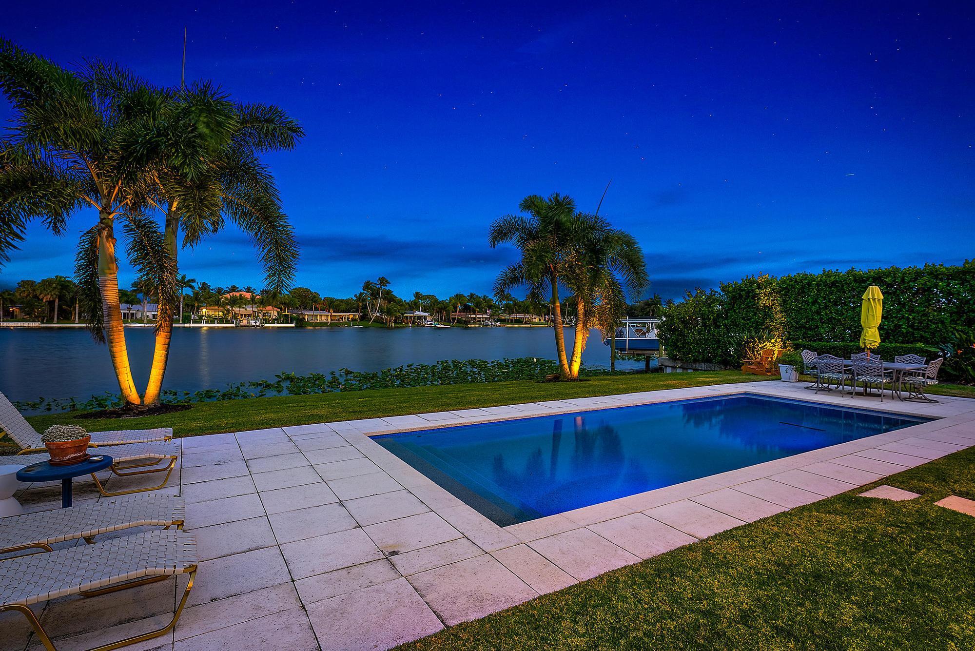 Waterfront! Gorgeous mid-century modern home over 3,000sf on a huge lot with wide panoramic views of Lake Clarke (spring fed freshwater lake & part of original Everglades) in the very desirable WPB neighborhood known as Lake Clarke Shores. This meticulously cared for light-filled property features 2 bedrooms (can easily become 3 bdrms) two & 1/2 baths, swimming pool, renovated kitchen, open beam vaulted tongue 'n groove wood ceilings, with living spaces designed to enjoy the water views. The many unique architectural details will delight! No HOA in this friendly boating community with miles of navigable waterways, private police dept, playgrounds, tennis & more while conveniently located near I-95, shopping, dining, local beaches, PBI airport & more! Carport can be turned into garage