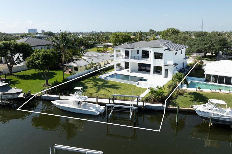 Immerse Yourself in Waterfront Luxury: Exquisite 5-Bedroom, 5.5-Bathroom 3.5 Car Garage, New Construction AwaitsThis stunning new build masterpiece, boasting a spacious 4,612 sq ft of living space on a sprawling 12,600 sq ft property, redefines waterfront living. Breathtaking water views, expansive living areas, and top-of-the-line finishes create a haven designed for luxurious living and effortless entertaining. As you arrive, the dramatic marble driveway sets the stage for the grandeur that awaits. Step inside and be greeted by the warmth of 9.5'' engineered wood floors flowing seamlessly throughout the downstairs living areas. The heart of the home lies in the gourmet kitchen, a chef's dream. Custom white shaker cabinetry provides ample storage, while full marble backsplashes add a