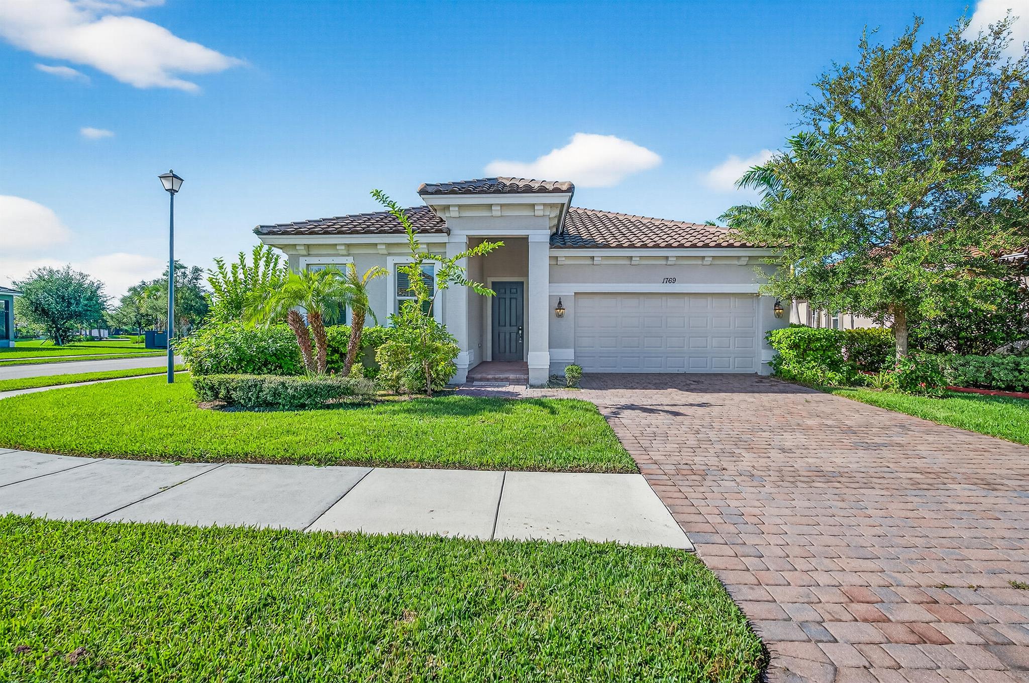 1769 Berkshire Circle SW, Vero Beach -- Lakefront living in Millstone Landing Impeccably maintained and thoughtfully designed, this 2019-built lakefront residence at 1769 Berkshire Circle SW offers comfortable, modern living in the gated Millstone Landing community. With four bedrooms and three baths, the home showcases bright, open living spaces and picturesque lake views that provide a serene backdrop for everyday life and entertaining. Built with quality in mind, the property features a durable concrete tile roof amazing value for the money