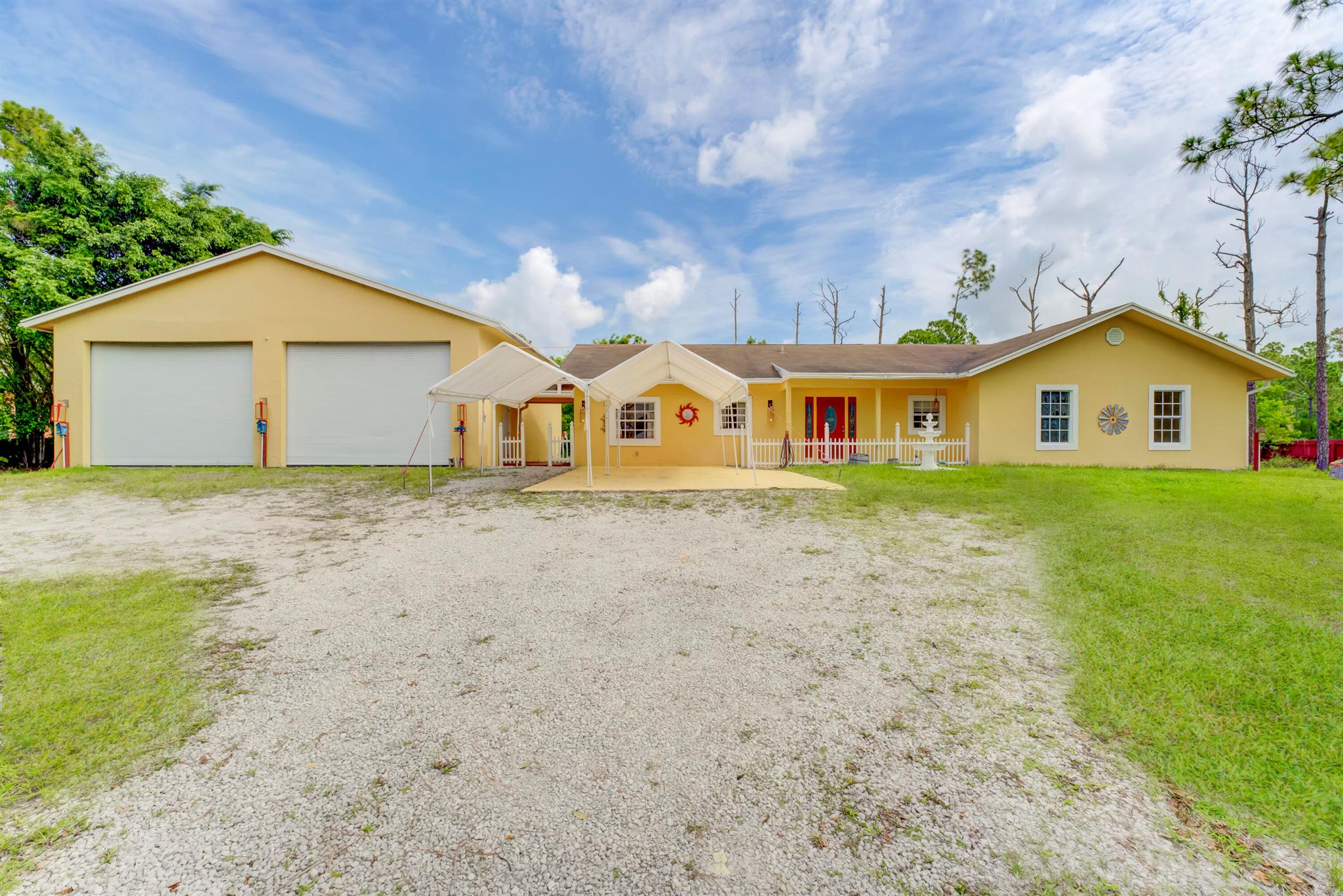 Make this home your own, 3-bedroom, 2-bath on a 1.4-acre lot. Located on a main paved road with a sidewalk.The spacious living area provides a comfortable space for relaxation along with a covered patio for entertainment. One of the standout features of this property is the impressive 1600 sqft workshop garage. Complete with a loft it provides endless possibilities for mechanics, RV storage, hobbyists, artists, or those in need of additional storage space.Zoned for agricultural use, this property offers a unique opportunity for those with a green thumb. The surrounding fence ensures privacy and security, allowing you to enjoy the expansive outdoor space with peace of mind. The large yard provides ample room for all your toys or even the addition of a pool or playground.With its