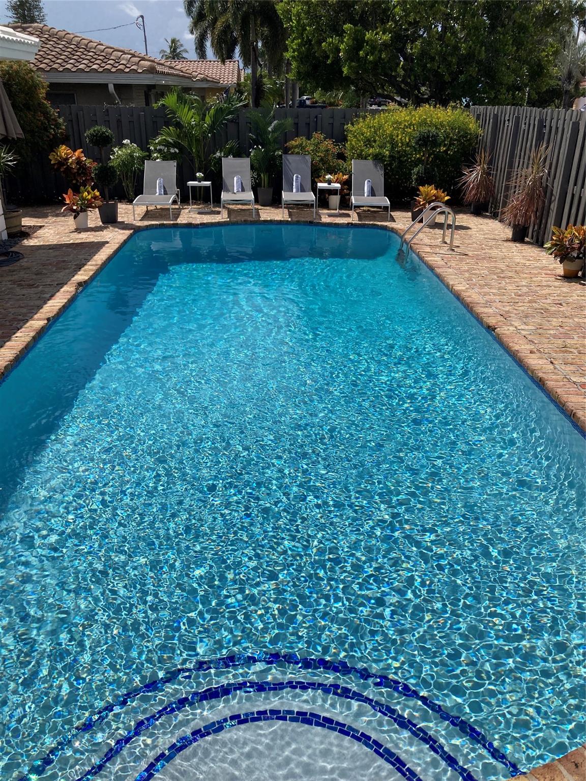 MODERN LUXURY UPDATED 4 BEDROOM 4 BATHROOM 2 FULL KITCHENS OVER 3200 SQ FEET. ENJOY THE PRIVATE LARGE SALT WATER HEATED SWIMMING POOL. ALSO HAS A SEPARATE PRIVATE HEATED SPA. THIS IS A LUXURY RENTAL WITH COVERED ATTACHED PARKING. IMPACT WINDOWS. CENTRAL AC. RECESSED LIGHTING. LED LIGHTING. BEAUTIFUL PORCELAIN FLOORS THROUGHOUT. 2 LARGE LAUNDRY ROOMS. LARGE CORNER LOT WITH CIRCLE DRIVEWAY. ENJOY LIVING IN THE GREAT CORAL RIDGE NEIGHBORHOOD. THIS PROPERTY IS ONLY MINUTES TO THE BEACH AND THE LAUDERDALE BY THE SEA DOWNTOWN BEACH AREA WITH ALL ITS RESTAURANTS AND NIGHTLIFE. THE BEACH IS CLOSE ENOUGH TO WALK TO. OWNER PAYS FOR POOL AND YARD MAINTENANCE. CAN ALSO BE LEASED FULLY FURNISHED OR POSSIBLY WITH A SHORTER TERM. PLEASE INQUIRE. SMALL PETS WELCOME WITH APPROVAL AND DEPOSIT.
