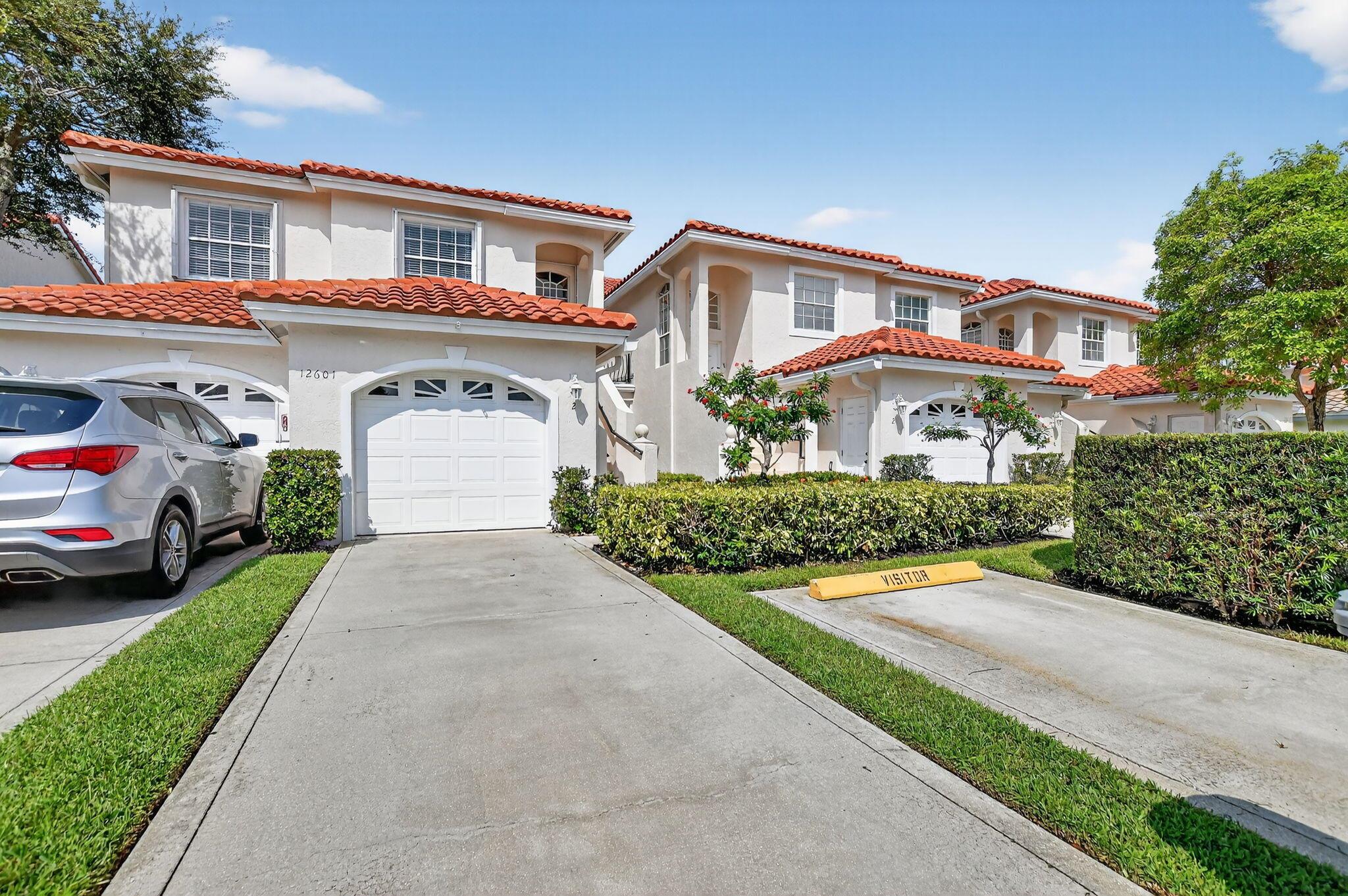 Welcome to your Dream Townhouse in a Stunning, all-ages, man-gated community with 24-hour security and Resort-Style Florida living! Surrounded by lush tropical landscaping, serene lakes, and sparkling fountains, this upstairs 2nd-floor residence offers the perfect blend of luxury, comfort, and convenience. Step inside to an open and airy floor plan with soaring vaulted ceilings, and a decorative fireplace that adds warmth and charm. The formal dining room flows seamlessly into the living room and out to a private patio overlooking lush garden views, creating the ideal indoor-outdoor lifestyle. The gourmet eat- in kitchen is a chef's haven, combining function and style with modern white cabinetry, gorgeous countertops, tile backsplash and sleek stainless steel appliances.