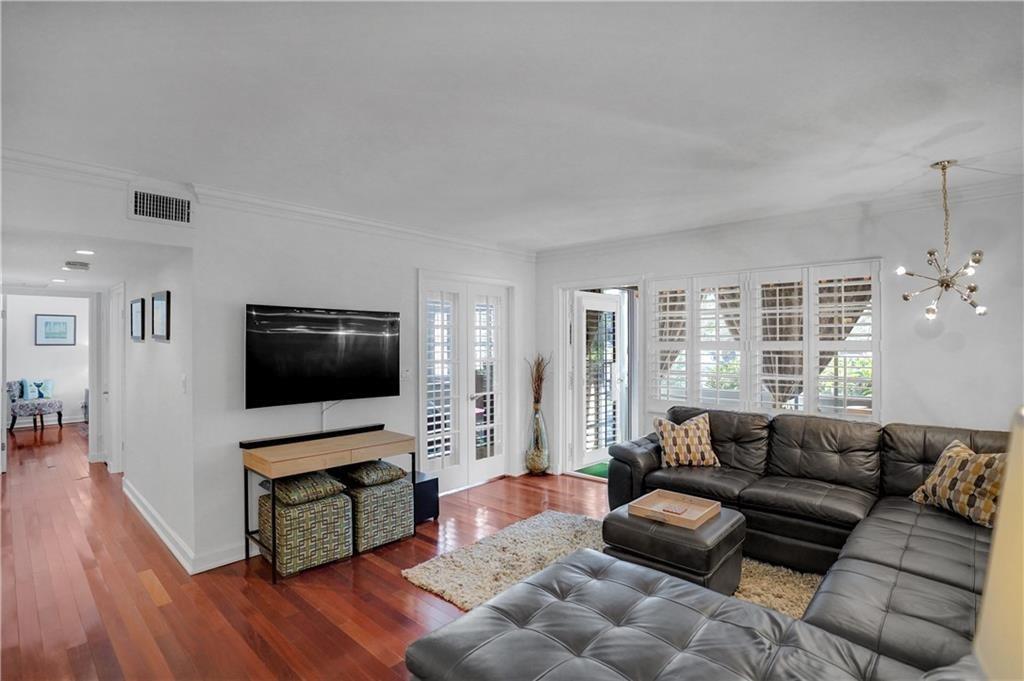 A rare find in Manor Grove Village (4)! This updated 2 bedroom | 2 bathroom unit is substantially remodeled. Newer kitchen with custom cabinetry, beautiful granite counters, brand new black SS appliances & stunning backsplash. Hurricane Impact Windows/Doors + brand new Hot Water Tank + newer A/C + new Plantation Shutters + Crown Molding + updated screened-in patio. There are pull down shutters for the patio. All real hard wood flooring throughout the living room and bedrooms. Parking space #24 right out the patio door for easy access to enter your home without walking through the hallway. Communal Laundry on each floor.