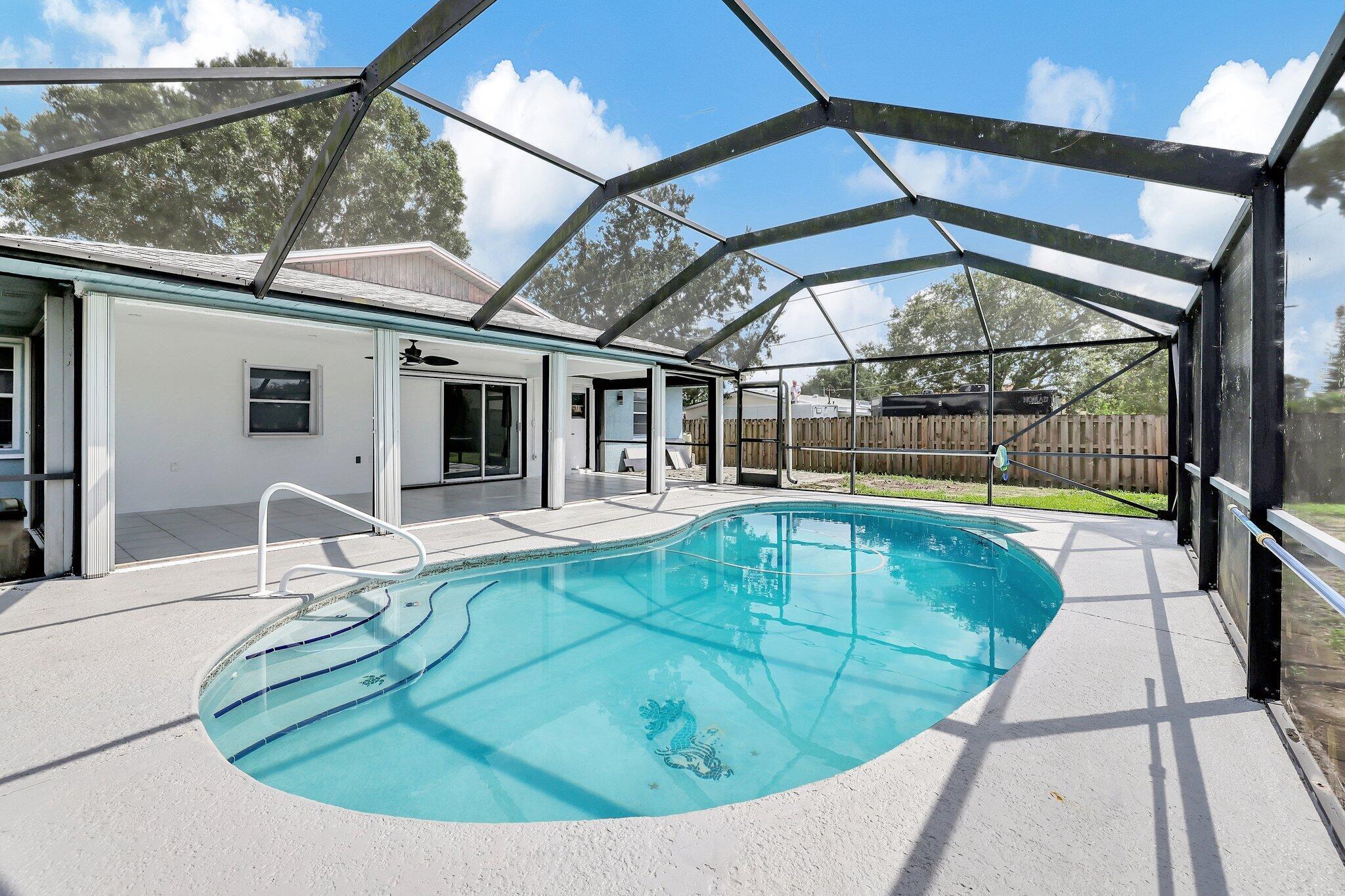 Welcome to this beautifully renovated 3-bedroom, 2-bath home tucked away on a peaceful street in Port St. Lucie. Featuring a 2024 roof, accordion hurricane shutters, and a stylishly updated kitchen, this residence offers both comfort and long-term value. The layout opens to a screen-enclosed pool area and a generously sized backyard, ideal for outdoor enjoyment and entertaining! This home is currently tenant-occupied through December 5, 2025--an excellent opportunity for investors seeking immediate rental income ($3,100/month). Advance notice required for all showings to accommodate the tenant.- Split-bedroom layout- Hurricane protection throughout- Large backyard with screened-in pool- One-car garage + ample driveway space- No HOA!