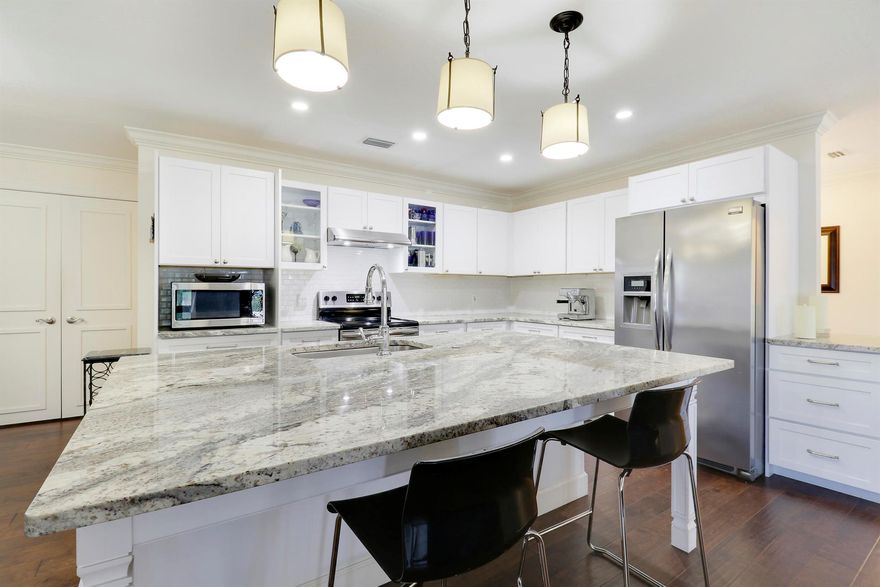 Experience quintessential Florida living on a rare half acre private retreat (and zero HOA fees) in the heart of coveted Sandpiper Bay. Completely renovated, this 3-bed/3-bath pool residence also offers a flexible den that could serve as a small 4th bedroom/office with ensuite & private entrance.Inside, sunlight pours through wide French doors, accentuating the huge open-concept great room that keeps everyone connected. At its heart is a show-stopping white kitchen -gleaming granite counters, large center island, Frigidaire(r) stainless appliances, deep drawers, and bar seating that bridges casual breakfasts and lively gatherings. The expansive living room flows naturally to the screened lanai, where a crystal-blue pool and generous covered patio invite year-round entertaining.