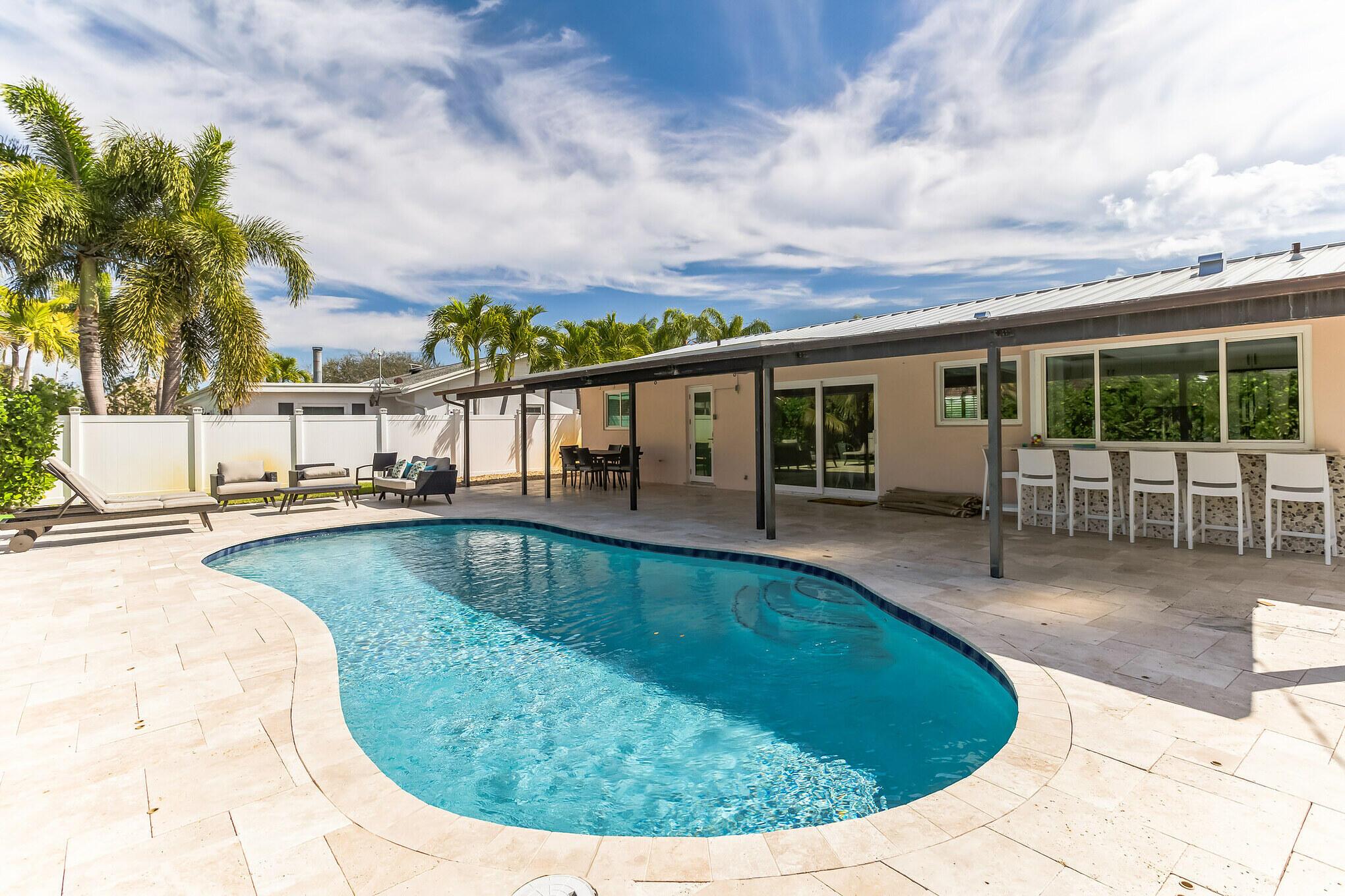 Welcome to 19 WIllow Rd, your next home! This home features 3 bedrooms 2 baths, a beautifully landscaped backyard including large picturesque pool and your very own artificial turn putting green. Relax under the covered porch or sunbath on the expansive outside patio. This home has a brand new metal roof(2022), brand new AC unit(2023), full miami dade standard impact windows, whole house generator, tankless gas hot water heater, in-ground 1000 gallon propane tank and more! This home will not last!