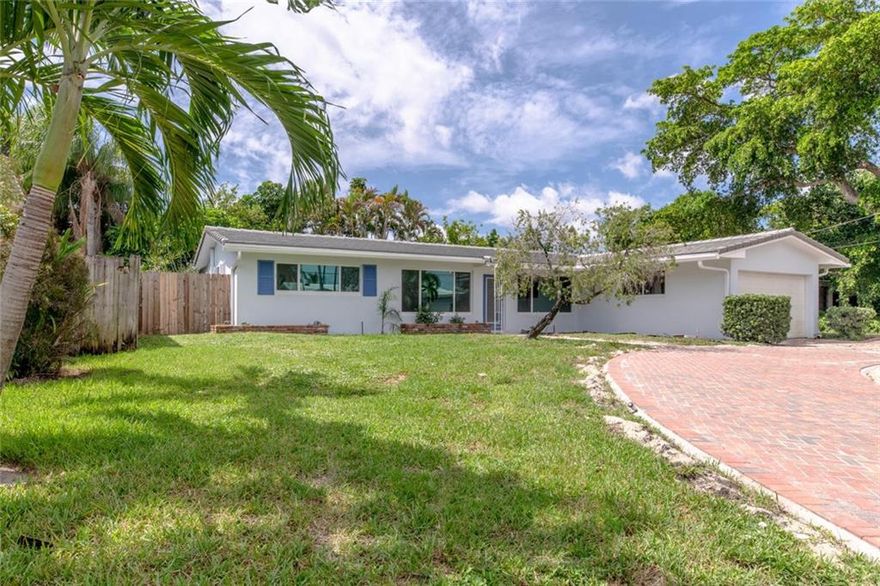 This beautifully remodeled 3/2 split bedroom floor plan has been completely remodeled with the following;New roof, new impact windows and doors, both bathrooms have been completely remodeled, kitchen remodeled to include new cabinets, quart counter-tops,  decorative tile back splash, new kitchen appliances, new electrical, tankless water heater, polished terrazzo flooring, interior and exterior of house has been painted along with a new brick paver circular driveway. Home has great light, large bedrooms, huge Florida room, fenced yard, 2 car garage and in a stellar location.