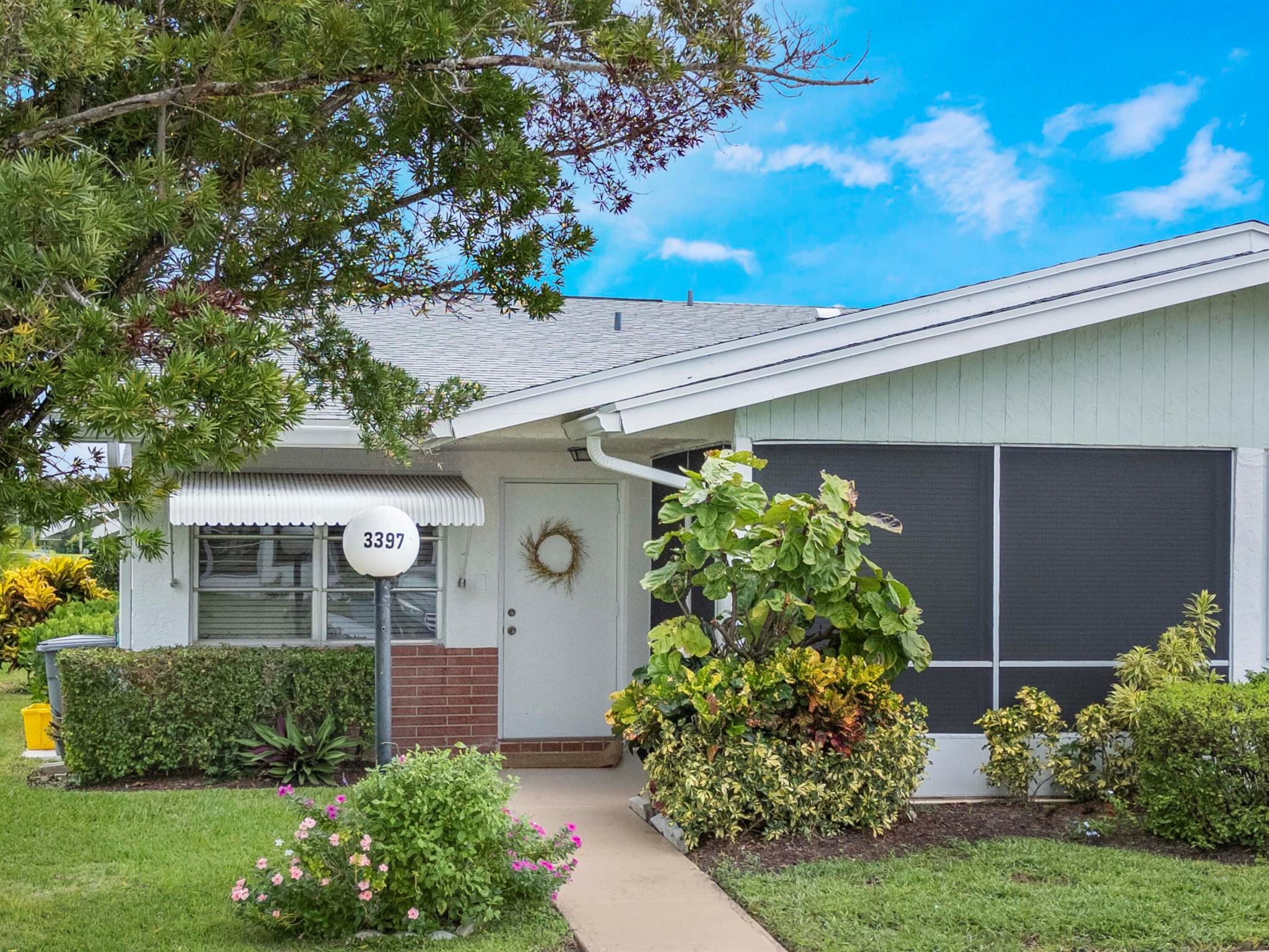 Charming 2/2 villa in the gated 55+ community of Cypress Lakes! Features include an updated kitchen with white shaker cabinets, quartz counters & newer appliances, remodeled bathrooms, full-size washer/dryer inside, accordion shutters & plenty of storage. Roof 2022. Spacious living/dining area plus a screened front patio & 2 parking spaces right outside your door. Community amenities include pool, golf, tennis, bocce & walking paths. Conveniently located near shopping, dining, I-95 & the Turnpike! HOA ($353) includes lawn care, security, internet, and cable!