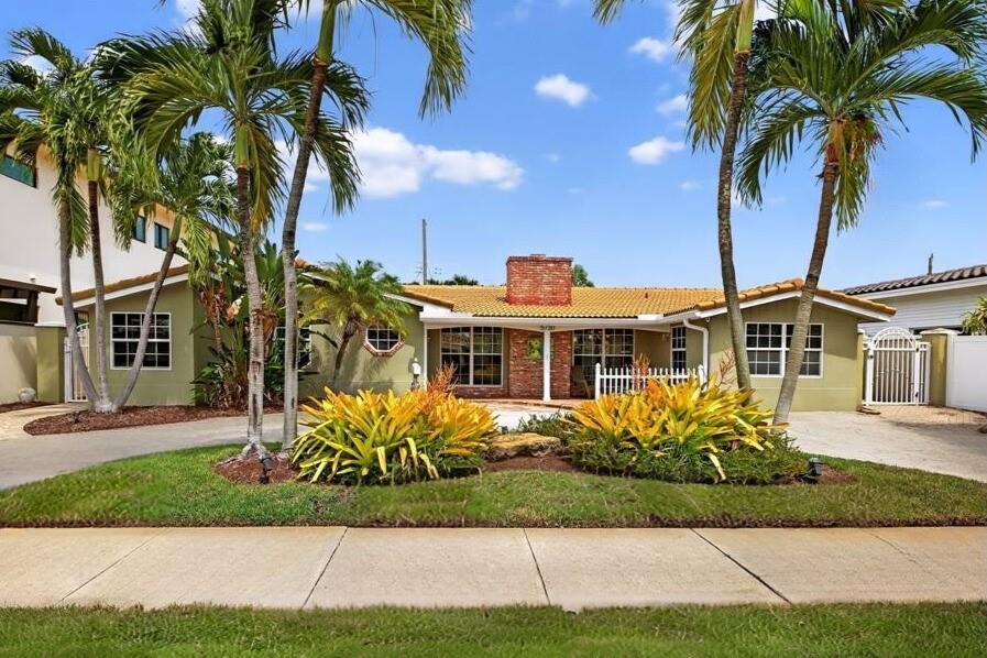 Welcome to your dream retreat in Imperal Point, just minutes to the beach! Own a slice of paradise with this 4 bed, 3 bath pool & spa home. Open floor plan featuring cozy wood burning fireplace, formal dining, living rm & spacious family rm. Private fenced backyard oasis with sparkling pool & spa, expansive travertine deck & concrete gazebo. Great curb appeal, inviting porch, circular driveway, exterior lighting, some Impact glass & large storage room. Walk to schools, places of worship & shopping, while the proximity to the beach means sun & surf are always within reach. Close to downtown Ft. Laud., airport, Westminster Academy, Pine Crest & more! If you are looking for a serene family home or vacation home, this one checks all the boxes w/ so much more. Must see to appreciate!