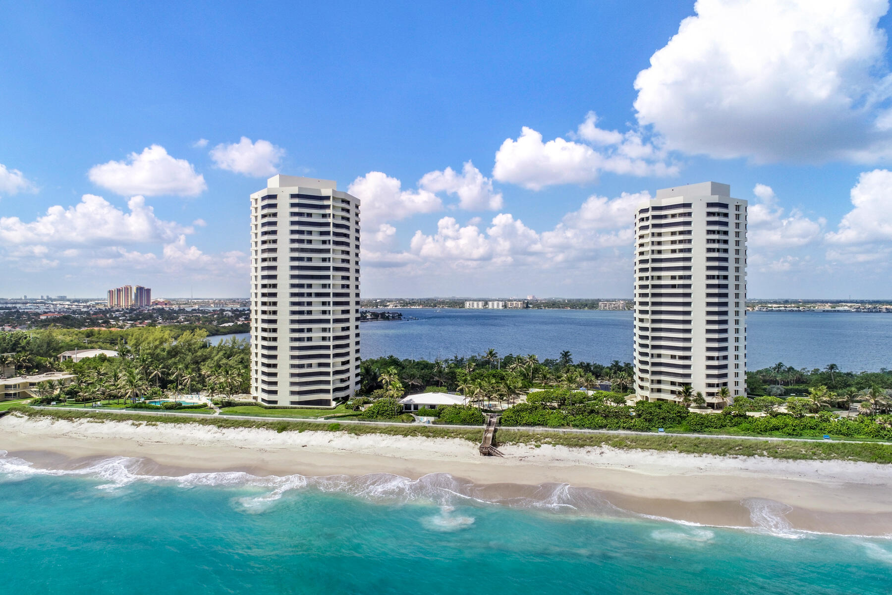 Stunning ocean Views and intracoastal views from this corner unit at Seawinds.  Recently remodeled throughout with large white porcelain tile, new kitchen and baths, and gorgeous, comfortable furniture.  The top of the line in every way possible. The entire condo is redone, modern in design and exquisite.  Washer and Dryer in ensuite laundry, garage parking under the building, in house manager, elec car chargers.  The building has just completed the SIRS and milestone inspections, so it is in top condition.  Fourteen acres to use for walks, beach days and exercise.  Enjoy walking the boardwalk along the seawall cap which is 900 feet long. Enjoyable parties and events held throughout the season.
