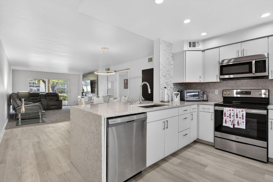 Beautifully remodeled kitchen featuring an open pass-through to the dining area. Upgraded window treatments and stainless steel appliances enhance the space. All ceilings are smooth, eliminating popcorn ceilings. The bathrooms have been updated, and the property is fully furnished or can be unfurnished. You'll like the furniture!