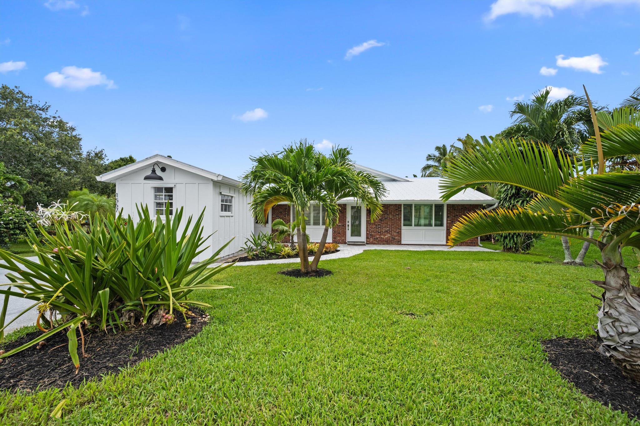 Discover this beautifully remodeled home nestled on a quiet street with No HOA. Completely renovated in 2025, this home feels brand new, featuring new flooring throughout; modern bathrooms with stylish finishes; gourmet kitchen with high-end appliances, new cabinets, premium countertops & walk-in pantry; full-impact glass windows & doors for peace of mind and energy efficiency; new roof in 2021 & new A/C in 2024. Step outside to your lush, private, fully fenced backyard - a true retreat with two spacious decks, perfect for entertaining or relaxing. Three workshops plus storage rooms. Enjoy the unbeatable location less than 5 mins. to Langford Park, Indian Riverside Park & downtown Jensen Beach. Only 10 mins. to the beaches & downtown Stuart.