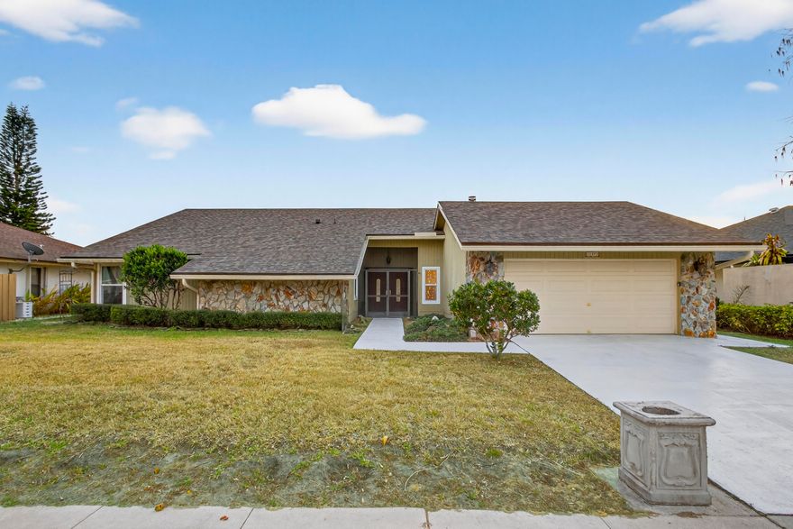 Welcome to 14372 Blackberry Dr, Wellington, FL, a beautifully upgraded one-level, 4BR/2BA/2CG waterfront pool home on .23 acres w/ NO HOA, in Sugar Pond Manor. Major upgrades include new roof- 2024, impact windows and sliders- 2020, two A/C units- 2024 & 2019, accordion shutters, epoxy garage floor, full irrigation & more! This home blends character & modern updates. A grand entry with solid double mahogany doors opens to travertine marble flooring in the main living areas & ¾-inch rose hardwood floors in BR's & DR. The LR features a cedar ceiling, stone wood-burning fireplace, wet bar w/ a custom copper sink & a Baby Grand piano; perfect for entertaining. The custom island kitchen offers wood cabs, granite c-tops, SS KitchenAid appliances + 2nd SubZero fridge w/ dual drawers, convection oven, raised dishwasher, custom built-in bench w/ bookshelf and many pots/pans drawers & pull-outs for ample storage. The spacious primary suite includes cedar wood ceiling detail, a built-in sauna, walk-in closet w built-ins, a bidet, onyx vessel sink & a sunken Roman tub w/ over 6' of marble. The second bath was newly reno'd w/ marble & a walk-in shower, crown molding in all BR's, custom closet in BR 2 with an additional large flex space that can be used as a walk-in closet, sitting area etc & all interior doors are solid six-panel wood doors. 

Enjoy water views from the screened lanai overlooking a 22,000-gallon resort-style pool featuring a rock waterfall, water slide, dragon water feature, and 6-person bench seating. The outdoor kitchen includes a built-in grill, two-burner stovetop, smoker, rotisserie, sink & Kegerator; ideal for South Florida living & entertaining. Wellington has great schools, restaurants, shopping and is internationally known as the 'Winter Equestrian Capital of the World.' Garage was fitted w/ additional work lighting & air compressor hose attached to the ceiling. Buyer will need to buy new compressor if they want to use it. Some TLC needed but big ticket items are done.