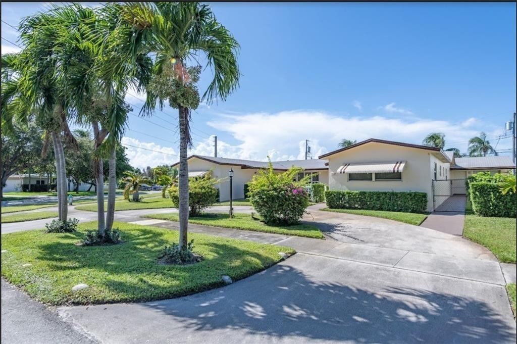 This large unit comes with a side yard. It includes a den that can be used as a third bedroom and has its own exit. One parking space is just outside the back door, and the half-circular driveway can accommodate 2 to 3 more vehicles. The kitchen is open and spacious, leading to a private side yard that is exclusively for this unit's use. The renovated kitchen has plenty of cabinet space, countertops, and a pantry. The bedrooms are roomy and have large closets. Occupancy can be immediate.