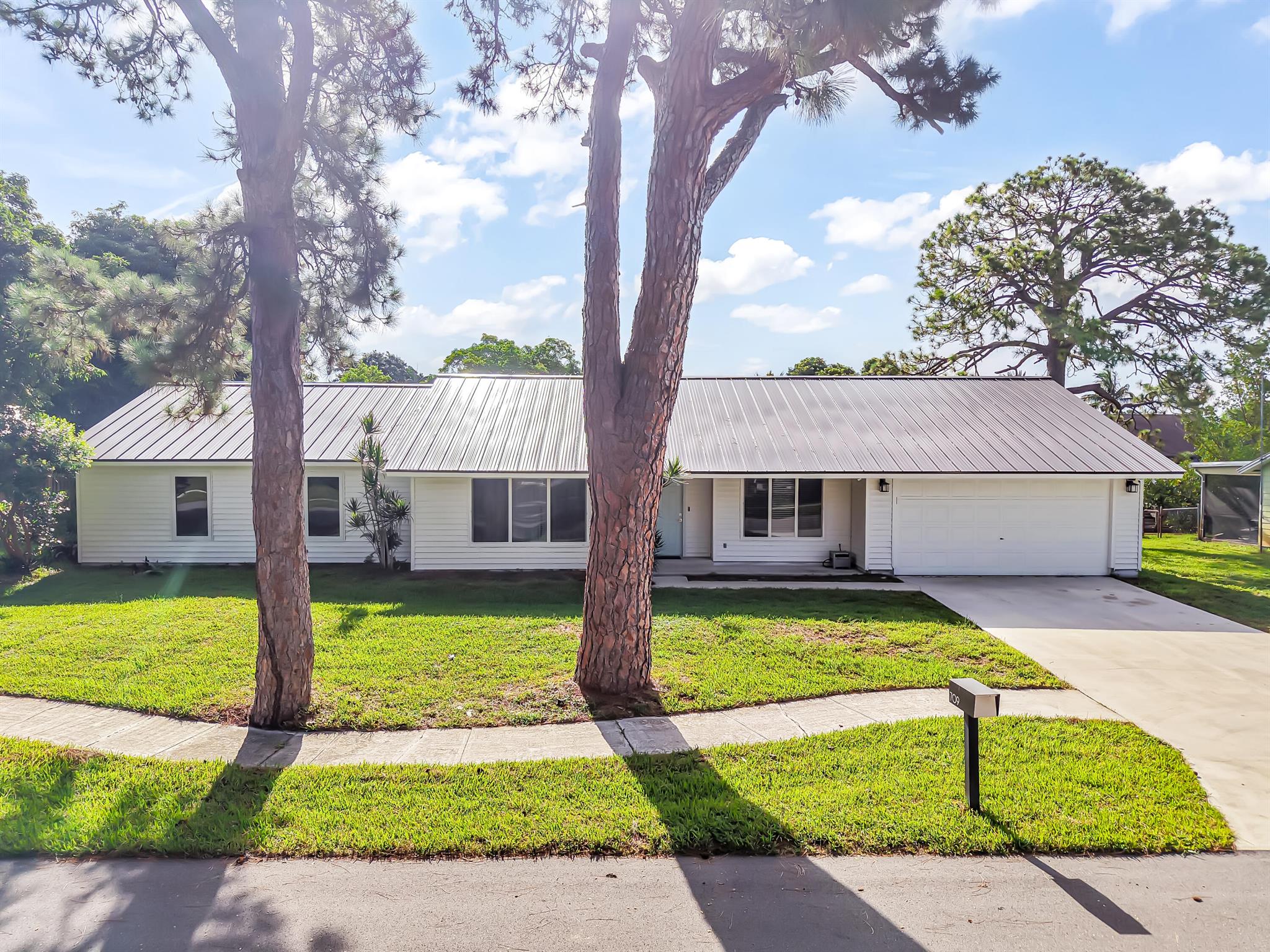 Imagine gliding down your private canal at sunrise, the pastel sky reflecting off calm waters as you head straight out to the Atlantic. Tucked into a peaceful cul-de-sac, 709 Warren Drive is a fully reimagined 4-bedroom, 2-bath waterfront sanctuary with no HOA. Outside, a brand-new metal roof crowns the home, New AC to cool you down in the Florida sun, a newly installed seawall safeguards your private dock--complete with hurricane-impact windows, and doors for ultimate peace of mind.