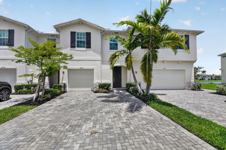 Modern Lakeside Living in Lake Worth | Gated Community 6933 Harbours Edge Avenue, Lake Worth, FL 33467  Discover the perfect balance of modern comfort and low-maintenance luxury in this beautiful 4-bedroom, 2.5-bathroom townhouse. Located in a premier gated community with 24-hour security, this home offers peace of mind and premium amenities in a highly sought-after location.  Serene lake views from private patio. One-car garage. Low-maintenance living ideal for residents, seasonal owners, or investors. Resort-style access. Home Features Open-Concept Design: The spacious floor plan is perfect for both daily living and entertaining, allowing natural light to flow through the home.  Gourmet Kitchen: Equipped with sleek stainless steel appliances, ideal for the home chef.  Smart Home Ready: Move in with confidence knowing your home is secured with smart locks and a Ring camera system.  Lakeside Serenity: Step outside to a peaceful rear patio featuring calming water views—your own private retreat for morning coffee or evening relaxation.  Convenience: Includes an attached garage for parking and additional storage.  Community & Lifestyle Residents enjoy exclusive access to the community pool and the security of a fully gated environment. This location is a commuter's dream:  Prime Location: Just 5 minutes from Florida's Turnpike, providing easy access to West Palm Beach and beyond.  Local Amenities: Minutes away from top-tier shopping, dining, and entertainment.  Rental Terms Included: High-speed internet is included in the rent.  Utilities: Tenants are responsible for water and electricity.