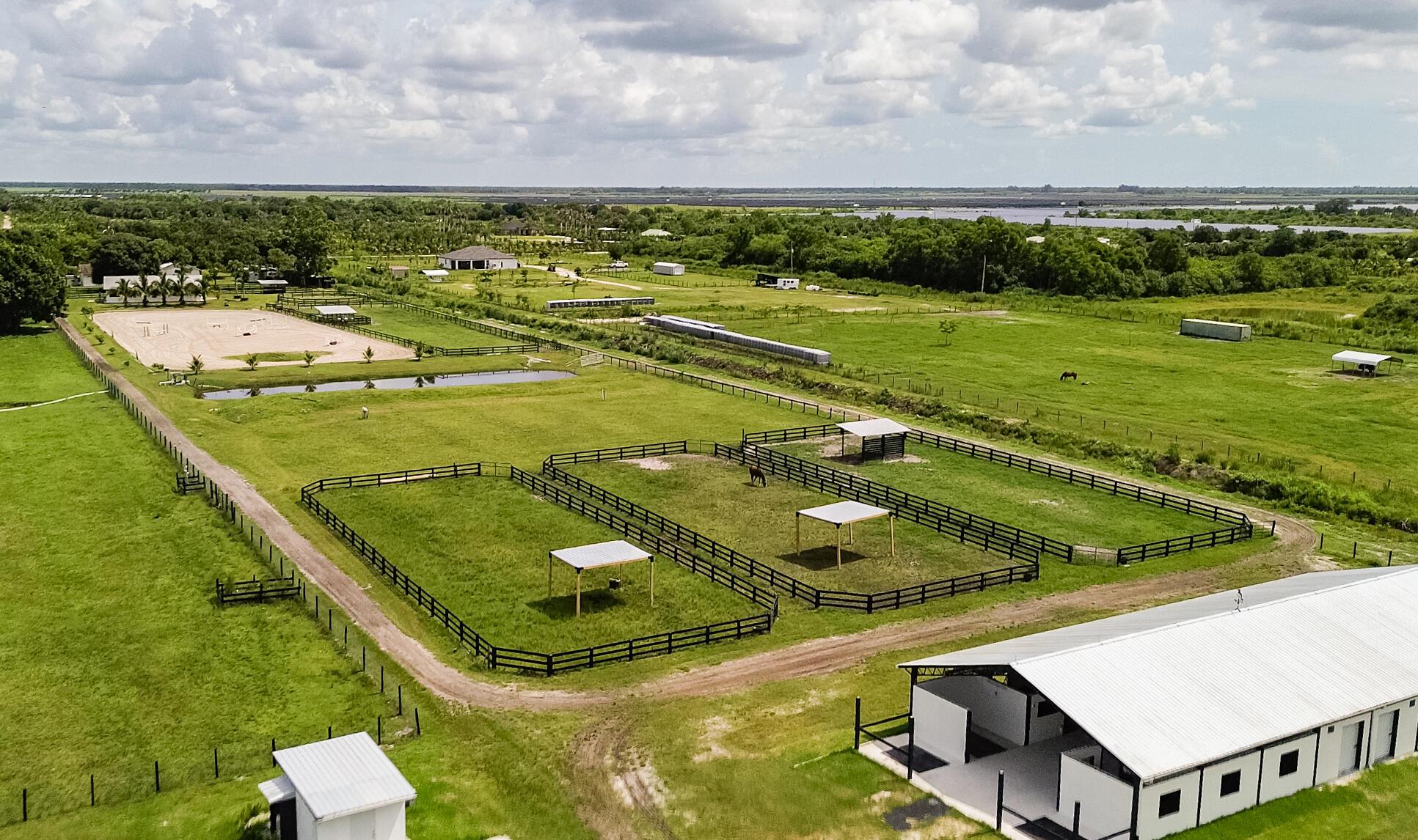 Horse Barn For Rent Seasonal or Long Term, Hurricane Rated CBS Barn, 10 Stalls Available 12 x 12 matted stalls, Equestrian Oasis on 10 Fenced Acres, Private and Tranquil Farm with an Abundance of Riding Space Irrigated Riding Arena 200 x 140 with Jumps, Grass Field 180 x 130, 1/2 Mile Galloping Track, Round Pen, Horse Swimming Pond, Spacious Tack Room with Air Conditioning Over Looking the Riding Arena, 3 Feed Rooms, Wash Rack, Laundry Room with Washer and Dryer, Bathroom, 8 Irrigated Grassy Paddocks - 4 Paddocks - Oversized with Run In Shed, 4 Grassy Paddocks, Short or Long Term Boarding Options Available, Additional Stalls if Needed, Spacious RV Also Available For Rent, and RV- Hook-Up Available, Conveniently Located 16 Minutes to the Showgrounds, Must See