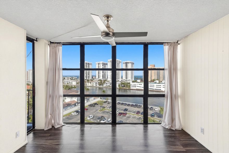 Captivating Water Views in Hallandale! Experience the ultimate lifestyle in this stunning 1-bedroom, 1.5-bathroom residence where natural light pours through massive floor-to-ceiling windows. The highlight of this home is the breathtaking unobstructed view of the canal with the ocean as your backdrop. This unit features a versatile layout with a dedicated den area perfect for a home office, an open concept kitchen ideal for entertaining, and exceptional storage including a generous walk-in closet in the primary suite. One assigned parking spot is included. Live with peace of mind in a well-maintained building featuring a fully attended lobby, security, an incredible swimming pool, and a fully equipped fitness center. Convenient laundry room on-site. Strategically located in Hallandale.