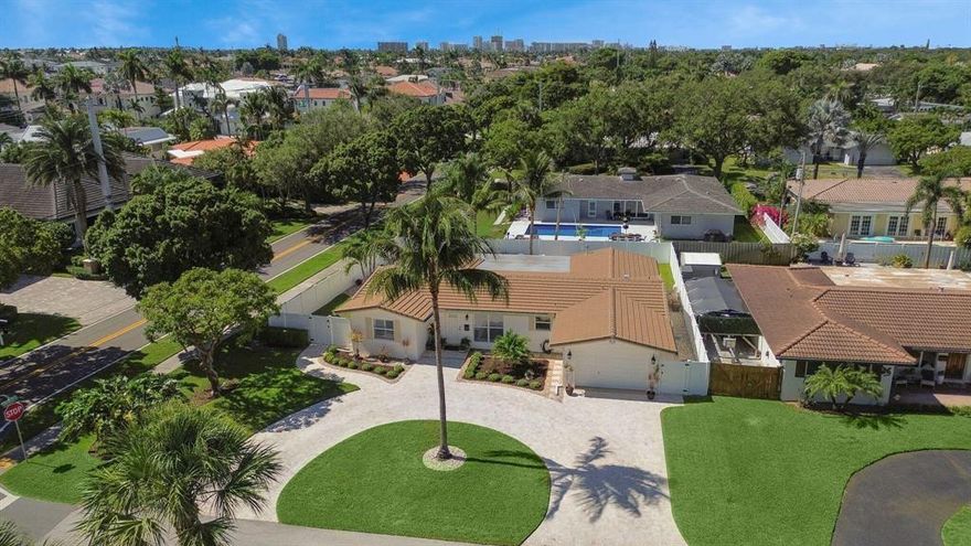 Welcome to your dream home in the heart of Lighthouse Point, Florida! This charming 3-bedroom, 2-bathroom corner lot oasis has been meticulously renovated. Step inside to discover a seamless flow of porcelain wood-look tile, leading you to a modern kitchen with granite countertops and top-of-the-line appliances. The home shines with impact windows and a 2021 roof, ensuring peace of mind. Enjoy the Florida sunshine in your private outdoor space, featuring a sparkling refinished pool and travertine-paved deck, perfect for gatherings. The home features a one car garage and circle drive, offering plenty of parking. This home truly has it all. Experience luxury and comfort in this beautifully updated residence!