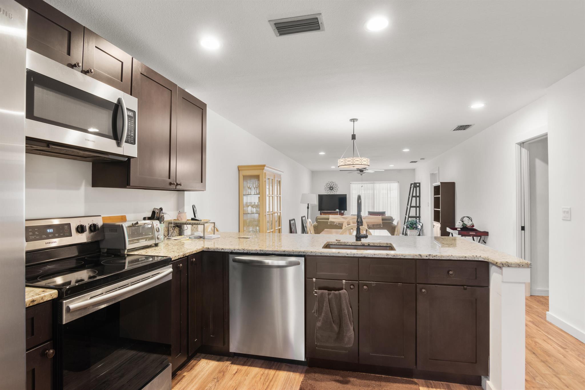 Discover this beautifully updated 2-bedroom, 2-bath villa-style condo in the sought-after Grove Condominium, a vibrant 55+ gated community in Fort Pierce. This single-story home offers an open, modern floor plan with stylish upgrades throughout -- including stainless steel appliances with warming drawer, solid wood cabinets with soft-close features, stone countertops, and recessed lighting. Both bathrooms are fully remodeled with wood vanities, stone tops, and frameless glass enclosures. Enjoy new flooring, fresh paint, upgraded trim, and elegant ceiling fans and fixtures.