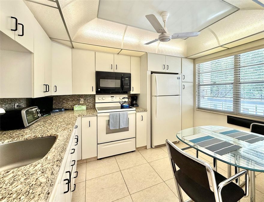 ACTIVE 55+ Wynmoor community! This second floor condo is available for short term rental as early as September, or rent it for one full year. It is also offered for sale! Features include an updated kitchen with granite countertops, a queen bed in the primary bedroom, a hi-rise bed in the guest bedroom, televisions in both bedrooms, and a glass-enclosed patio. Enjoy the BBQ and pool area right outside your back door. Four month minimum rental required. Live your best life with golf, theater, fitness center, clubs, pools and so much more! Everything you need is here and ready to enjoy. All you need is your bathing suit. Excellent location near shopping and restaurants in a secure community with a 24-hour manned gate.