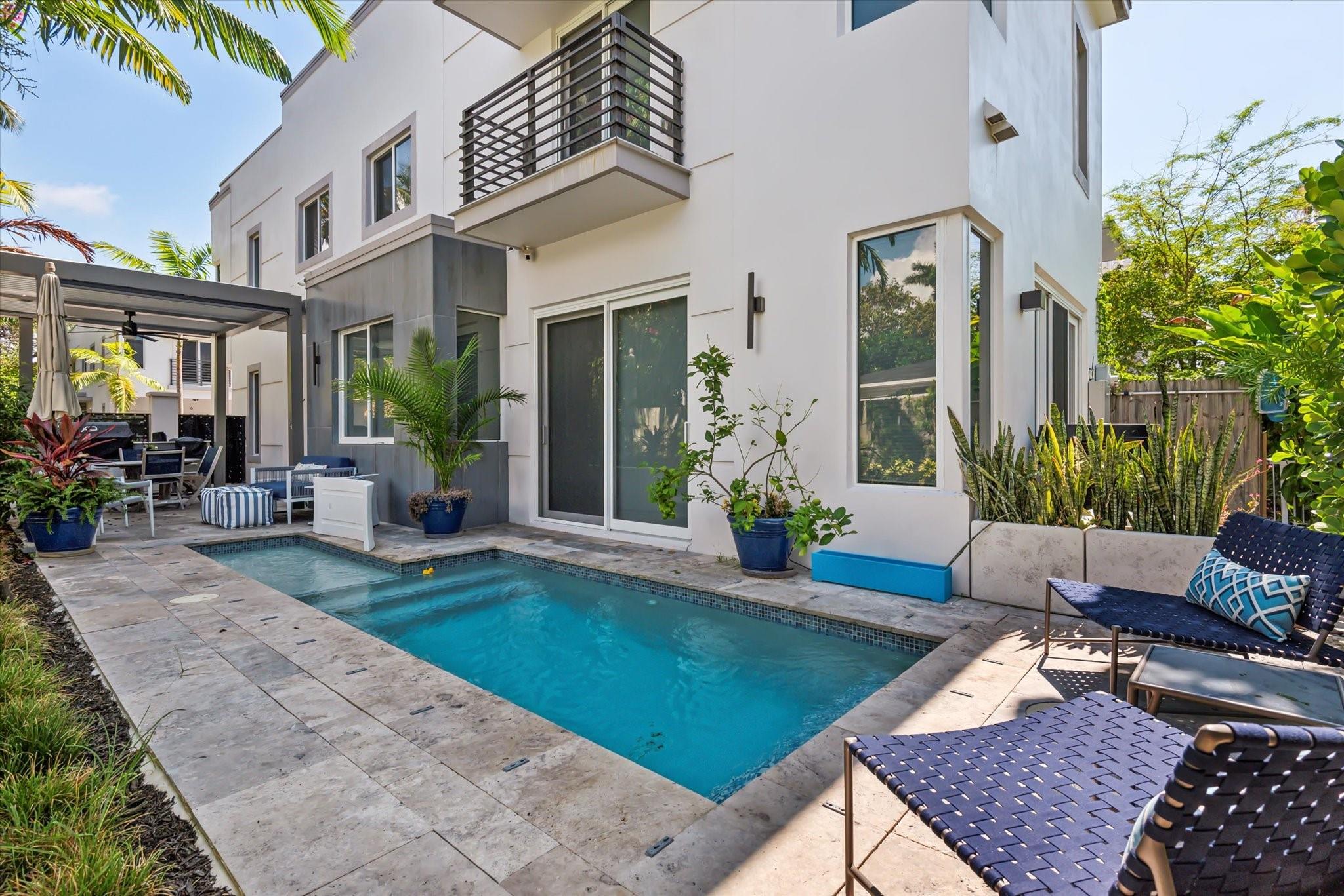 Modern corner-unit townhome in sought-after Victoria Park! This 3BR/2.5BA home offers quality finishes, tile & laminate floors, impact windows/doors, and recessed lighting. Expansive living area with floor-to-ceiling glass provides great natural light & pool views. Italian-designed kitchen with SS appliances, custom cabinetry & quartz counters. Private backyard features a heated/cooled saltwater pool, outdoor kitchen & motorized pergola. 2-car garage. Walk to Las Olas Blvd, close to beach, airport & highways.