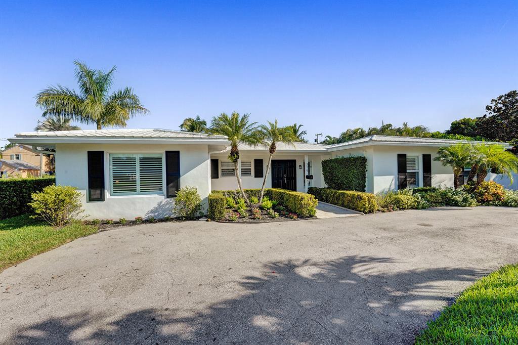 Enjoy the Lake Ida lifestyle in the most desirable community in Delray Beach! This gorgeous 4 Bed/4 Bath UPDATED single story home sits on a third of an acre tropical oasis . Beautiful wainscoting feature as you enter the grand dining room, this home has attention to detail & design. Offering, two owners suites, as well as a Guest /In-Law suite and bedroom with adjacent courtyard patio. The home has a bonus room which is currently being used as an Office/Den. Relax in the covered patio veranda, which is perfect for entertaining whilst enjoying the views of the heated pool in a private setting. Newly updated kitchen & laundry room, which includes a mudroom area and cabana shower. Open plan living areas, with floor to ceiling windows overlooking the pool.