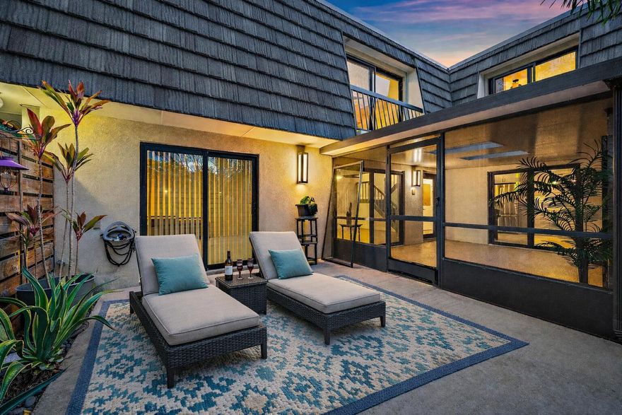 Welcome to your own slice of paradise in the heart of Glenwood at PGA National. From the moment you arrive, the enchanting tree-lined streets set the tone for this charming and sought-after community. This beautifully updated two-story townhome offers two bedrooms and two and a half bathrooms, blending comfort, style, and the ideal balance of privacy and neighborhood living.  A gated and fenced courtyard welcomes you home, featuring an expansive covered and screened patio that creates the perfect setting for outdoor dining, entertaining, or simply relaxing in the Florida breeze. Inside, the home has been thoughtfully updated throughout, including wood tile flooring and carpet on the stairs, enhancing both the aesthetic appeal and ease of maintenance. The centerpiece of the home is the stunning open-concept kitchen, designed to impress with quality, soft close cabinets, pull out shelving and bar, quartz countertops, a stylish tile backsplash, and stainless-steel appliances including a cooktop, vent hood, double wall oven, and a new refrigerator. A farmhouse sink adds a modern touch, while the adjacent breakfast area provides a cozy spot for casual meals. Abundant natural light flows through multiple sliding glass doors, seamlessly connecting the kitchen to the dining and living areas as well as the outdoor patio, creating an effortless indoor-outdoor lifestyle.  Upstairs, the spacious primary suite offers a peaceful retreat, complete with a walk-in closet, an additional closet, and a well-appointed en-suite bathroom featuring dual vanities and a beautifully tiled shower. The second bedroom is equally inviting, offering generous space and wall-to-wall closets. The home also features all impact windows and sliders.  Living in Glenwood at PGA National means enjoying a resort-style lifestyle with access to an impressive array of amenities, including a community pool, tennis and pickleball courts, basketball, scenic bike and jogging paths, a fitness trail, playgrounds, picnic areas, and a clubhouse, all within a beautifully maintained setting with sidewalks and street lighting. The location is equally appealing, just minutes from premier shopping, dining, and the Palm Beach Gardens Mall, with Palm Beach International Airport less than a 20-minute drive away.  This exceptional townhome offers the perfect combination of updated living, community charm, and convenience—an opportunity not to be missed.