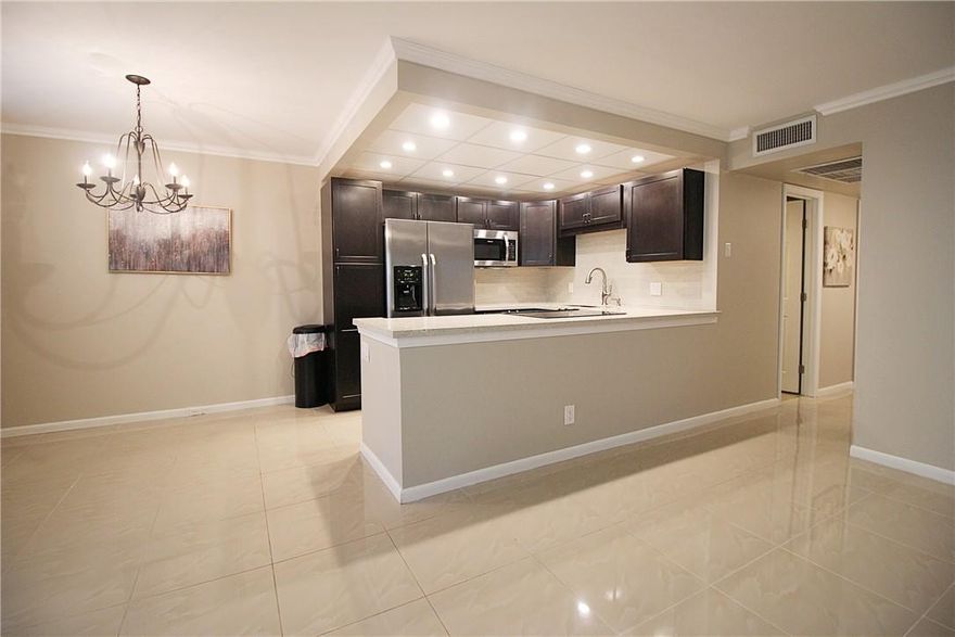 BEAUTIFULLY REMODELED 2 BEDROOM, 1.5 BATH ON THE GROUND FLOOR! THIS CONDO FEATURES AN OPEN KITCHEN W/QUARTZ COUNTER TOPS, GLASS TILE BACKSPLASH, FRIGIDAIRE SS APPLS & RECESSED LIGHTING.  MANY UPGRADES INCL LG TILE FLRS & CROWN MOLDING THRU-OUT, SHOWER STALL IN BTHRM, 5 CEILING FANS, FRENCH DRS IN GUEST RM, ENCL PATIO W/HURRICANE IMPACT GLASS SLIDING DRS. NEW HOT WATER HEATER & A/C 2018. STEP OUTSIDE ON YOUR PRIVATE BRICK PATIO OVERLOOKING A SERENE TROPICAL LANDSCAPED VIEW! CONVENIENTLY LOCATED CLOSE TO THE WEST GATE(24 HR ENTRY) & SHORT WALK TO POOL & TENNIS! DON'T MISS THIS OPPORTUNITY!  THIS 55+ ADULT COMMUNITY HAS FREE TRANSPORTATION INSIDE & OUT! THE AMENITIES INCLUDE A LAVISH CLUBHOUSE W/A 1500 SEAT THEATER, STATE OF THE ART GYM, TENNIS, INDR/OUTDR POOLS & MUCH MORE! ASSOC. CLAIMS 55+