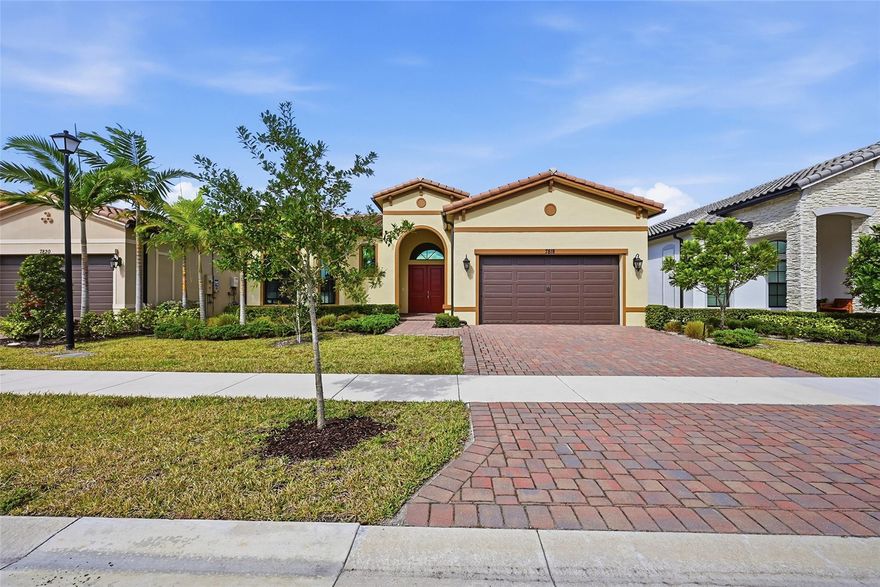 Introducing this stunning one-story lakefront home in the Falls at Parkland! Featuring 3 bedrooms, 2.5 baths, and a 2-car garage, the home boasts a modern kitchen with granite counters, a spacious island, sleek white cabinetry, pantry, and stainless steel appliances including a gas range. Each bedroom offers laminate flooring and large walk-in closets. Enjoy beautiful sunsets and serene lake views from your patio. Additional features include impact doors and windows, cathedral ceilings, a full laundry room, and a luxurious primary suite with dual vanities. Residents enjoy resort-style amenities, including a clubhouse, fitness center, pool, spa, pickleball, theater, ballroom, café, and more—perfect for an active and vibrant lifestyle.