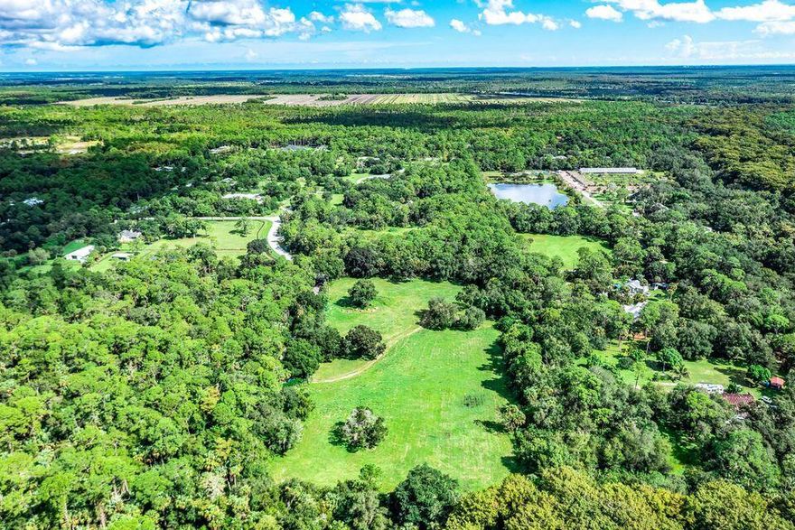 This is one of the finest 5 acre parcels available in Jupiter. Flat, dry and cleared this private location is for a country estate or small ranch. Close to shopping, golf, & equestrian activities. Soil tests, survey and set of plans are available. Zoned agricultural with beehives (will be removed if necessary) but provide great tax relief.