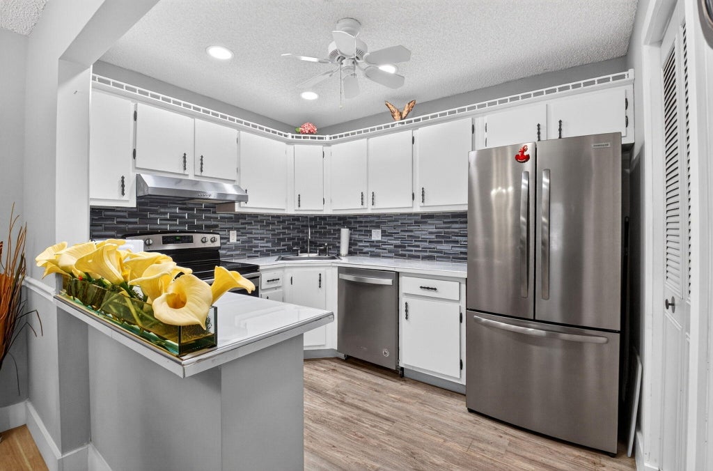 Photo of 5931 Whispering Pine Way #D-2, Greenacres, FL 33463 (MLS # B26080067)
