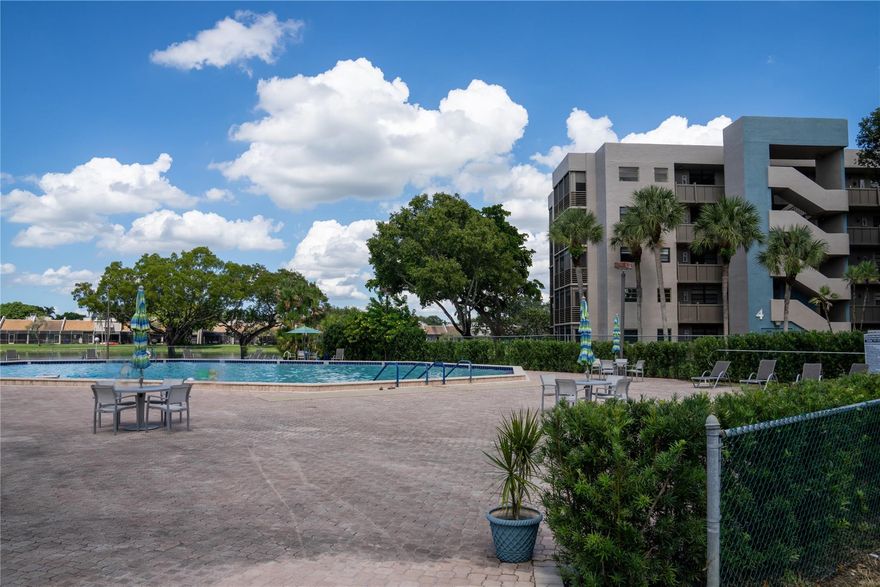 MAJOR PRICE IMPROVEMENT! DON'T MISS THIS OPPORTUNITY to own in the heart of Pembroke Pines. This second floor, 2 bed 2 bath unit, is a wonderful opportunity for someone with the right vision to update and personalize to their style and preference. Enjoy a quiet, guard-gated, 55+ community with private balcony overlooking a serene lake. Residents can relish in resort-style amenities including a heated pool, spa, tennis courts, fitness center, billiards room, theater, and so much more. Ideally located near Pembroke Lakes Mall, restaurants, shops, major highways, Memorial Hospital and the community is on the hospital power grid, ensuring power even during outages. Can't beat this offer to create your new home with all the comforts and conveniences of an unbeatable lifestyle.