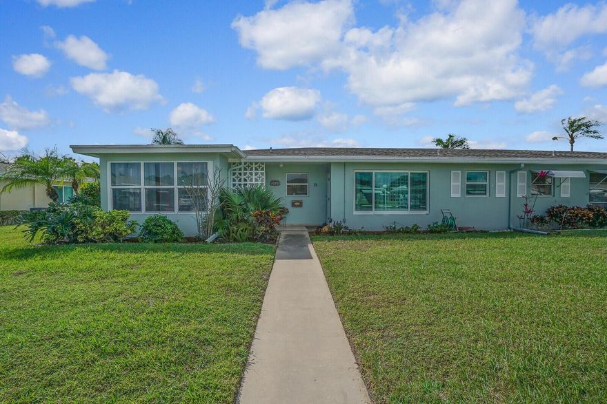 Discover comfort and charm in this beautifully updated corner villa, offering a peaceful retreat with modern upgrades and resort-style amenities. This villa boasts crown molding, neutral tile throughout, hurricane impact windows (2021), A/C (2022), electrical panel (2021), refrigerator(2022), dishwasher (2022), washer and dryer, newly painted (2022), and convenient parking. Currently used as an office, the bonus room can be a den/hobby room/man cave. Relax on your private patio, perfect for quiet morning coffee or evening entertaining. Beyond your doorstep, immerse yourself in a vibrant community with planned social activities, tennis and pickleball courts; the clubhouse and heated resort-style pool overlook a tranquil lake. All conveniently located to everything!