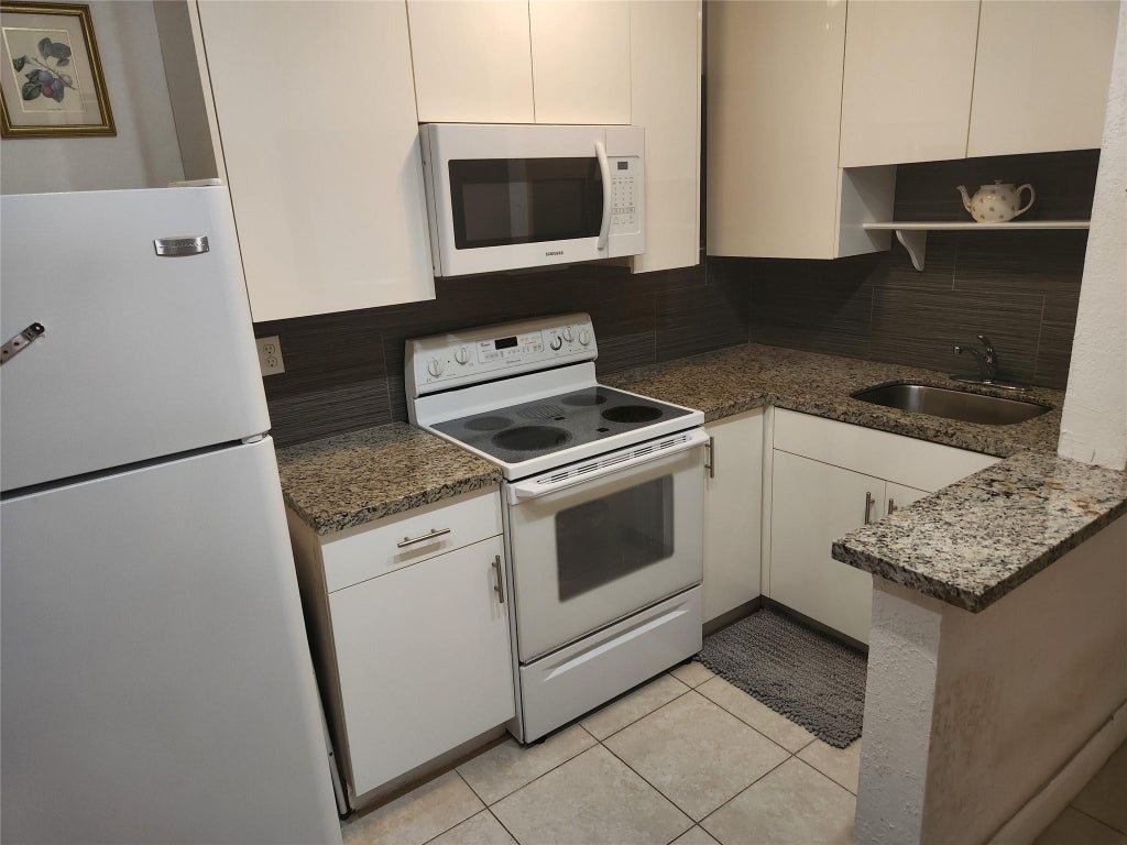 Photo of 1597 NE 53rd Court, Pompano Beach, FL 33064 (MLS # B26040847)
