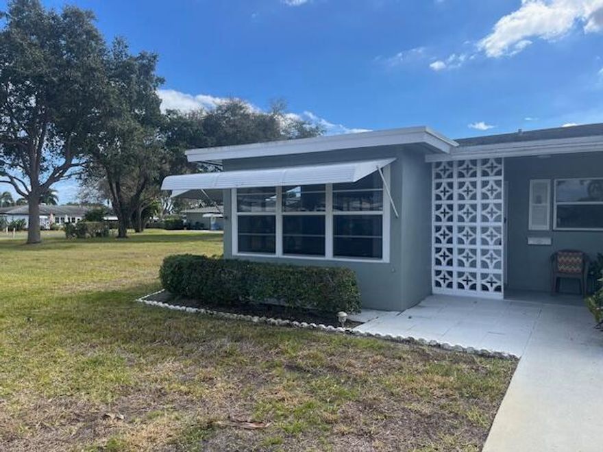Fabulous Find in High Point of Delray which is a 55+ age community. End location with lots of windows- impact glass to see the lovely green views. Sunny & bright 2 bedroom 2 bath + Enclosed patio/Sunroom/Florida rm more space to enjoy.. Updated Kitchen is open & gorgeous w/ granite. Baths are also updated. Ceramic tile flooring & carpet in liv rm & bedrooms. The Assoc fee includes water, sewer, wifi, Bldg Ins, & TV/cable. The Clubhouse & Pool are close. The Furniture stays except for kitchen table & chairs, rocking chair & twin beds in guest room. The laundry room(washer & dryer) is attached just a few steps from backdoor. Open patio area in back also nice for relaxing. Emotional support pets only & If buyer getting financing 10% down per assoc. Poss Seller financing, they are Motivated!