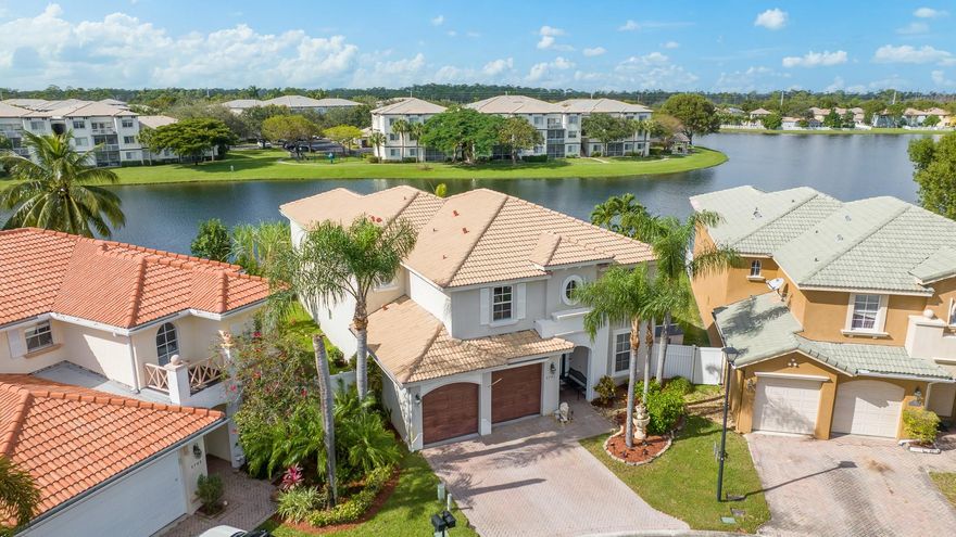 Imbued with elegance the highly desired commodore 5 bedroom 4 bathroom pool home in the popular gated community of Briar Bay rests on an oversized pie shaped lot at the end of a private cul-de-sac. As you step inside you are greeted with unobstructed lake views, expansive open formal dining and living with abundant natural light. The thoughtful floor plan of the spacious home is designed for entertaining, with extended volume ceilings, large open chefs kitchen, sliding doors that seamlessly transition to the covered outdoor living area providing the perfect setting for enjoying the Florida lifestyle! Some of the many top tier upgrades and features of this home include all impact windows and doors installed in 2021, a downstairs suite with cabana bathroom, a bonus room/den, a wet bar, a grand staircase leading to a bonus landing, a huge upstairs owners suite with a spa like ensuite adorned with his and hers vanities, Roman Tub, walk in shower and dual walk in closets. There are three guest bedrooms upstairs, one boasting its very own ensuite and the other two share a jack and Jill. The custom salt water pool and paved deck area provide an enviable private resort style retreat ideal for entertaining family and friends while enjoying the incomparable sunset view over the lake! Briar Bay is a truly welcoming, desirable and low HOA community featuring many amenities including a club house heated pool, jacuzzi, splash pad, children’s play park, Tennis courts, a fully equipped gym, and beautiful trails surrounding the lake perfect for biking, running and dog walks. Located only minutes away to many of the regions best restaurants, schools, shopping centers, Florida’s turnpike and Palm Beach International Airport.