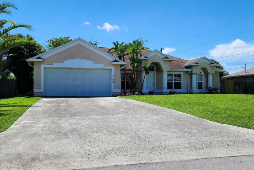 Solid 3-bedroom, 2-bathroom Port St. Lucie home offering 2,006 sq ft with strong upside potential and immediate usability. The layout includes an open floor plan, dining area, and a separate flex room ideal for an office, den, or possible 4th bedroom.Major systems are in good shape: A/C replaced in 2020, water heater replaced in 2024, and the original 2002 roof has been professionally inspected twice within the last six months -- with an estimated 5 years of life remaining. The home is fully move-in ready and sold AS IS, giving a buyer the opportunity to update over time while preserving equity.The screened-in patio overlooks a spacious backyard with mature trees, including a mango tree, and plenty of room for future improvements or outdoor projects. Local canals nearby offer