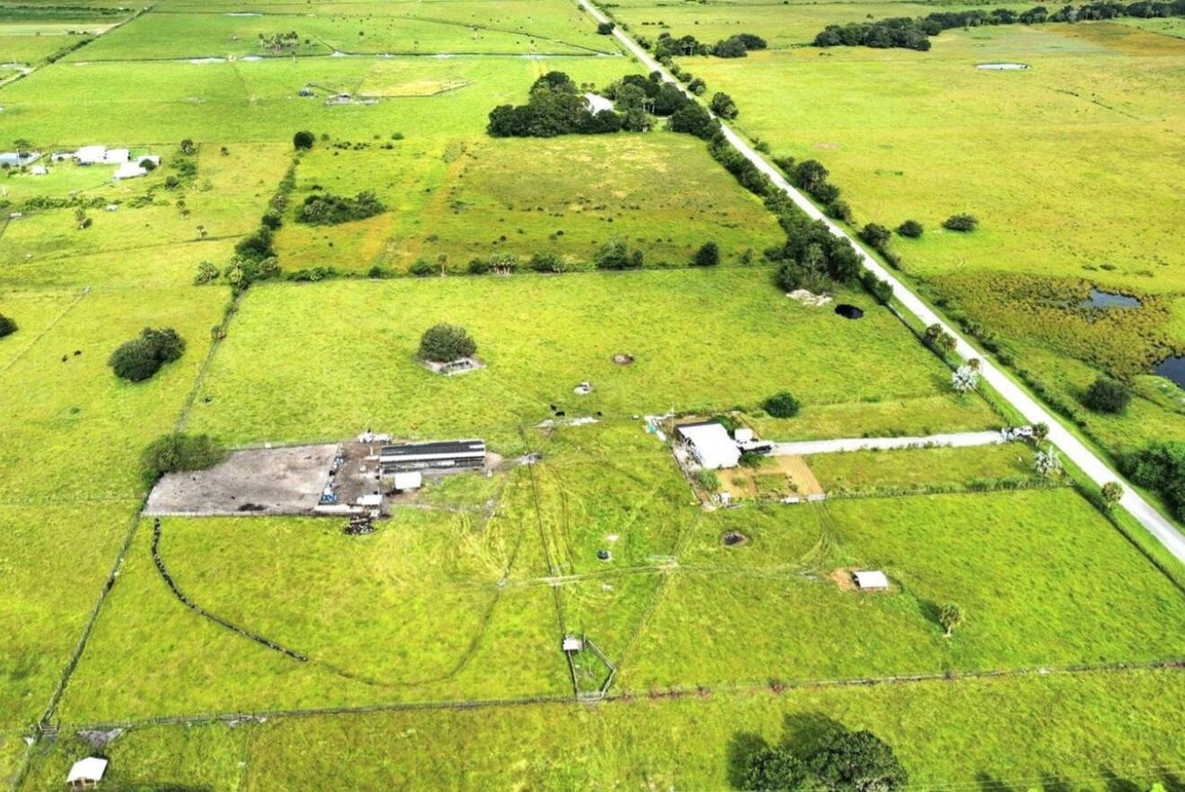 Beautiful acreage to build on 10 ACRES of serene property on a paved road. Enjoy amazing sunsets and spectacular start filled night stars. Pasture fenced and crossed fenced. Includes: 75' x 32' Pole barn with metal trusses with converted rubber proof roof. 20 x 20 chicken coop. 11 x 11 concrete pad with metal roof. Hug pen. Septic tank and drain field. Water well. Electric 200AMP. Mature trees Oak, Palms, Fruits. Close to US-441N, Turnpike, shopping, hospitals and more...Call for a free tour today!