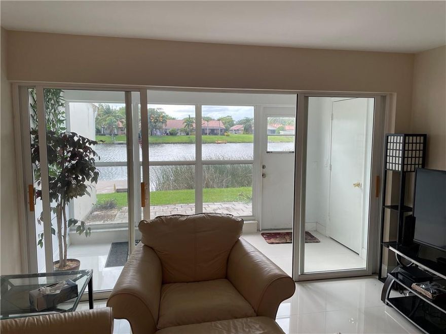 Spectacular water views and sunsets from this beautiful first floor unit.  Back yard faces Rainbow Lakes over looking boats and single family homes.  Unit has been updated with 42" white shaker cabinets, soft close cabinets, lazy susan, large pantry and Samsung appliances. No walls in kitchen and Living room, total lake views thru out the condo. Quartz counter tops with extended breakfast bar, Barn door covering washer and dryer unit.24 x 24 porcelain tile and wood like in both bedrooms. Patio is enclosed and there is also an open outdoor living area for a barbecue. new AC, accordian shutters. Beautiful unit just minutes to downtown Atlantic ave. Close to beach and 95. Two comunnity pools, Tennis courts and clubs with activities. spectacular first floor unit perfect place to retire.