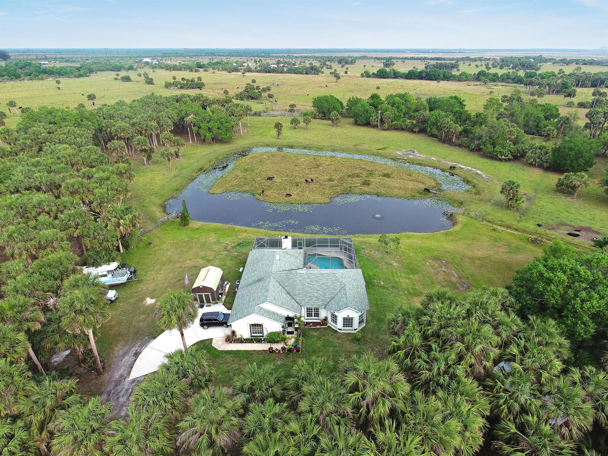 16 +/- Acres in this Beautiful Ranchette off Carlton Road that has a long private road that leads you to a home and split into 2 parcels. The house is on 4.91 Acres with a house and pool, and part of the pond is Homesteaded, and 11.24 Acres surrounds the almost 5 Acres and is AG exempted and has cattle on this part of the property. The house has 3 Bedroom, 2 Bath, 2 Car Garage CBS home with a screened in pool. Enjoy country living at its best and away from the city limits. This home has a split plan with 2000 sq feet under air and is clean with Tile floors throughout the house. Formal living and dining and a Large Family room with a working wood burning fireplace just off the Kitchen. This home is perfect for entertaining. This home is perfect for entertaining.
