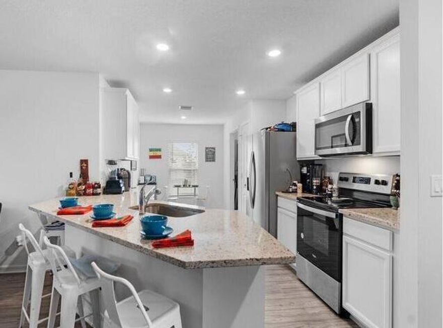 Experience refined living in the Bokeelia Model, a beautifully built 2021 home in the desirable Celebration Pointe community of Fort Pierce. Conveniently located near Interstate 95 and Florida's Turnpike, it offers easy access to shopping and pristine beaches. This thoughtfully designed residence features a spacious open layout with high-end upgrades throughout. The modern kitchen boasts elegant granite countertops and premium stainless steel appliances by Whirlpool. Enjoy a fully fenced backyard with tranquil lake views, perfect for relaxing or entertaining. A move-in-ready home offering comfort, style, and exceptional value.