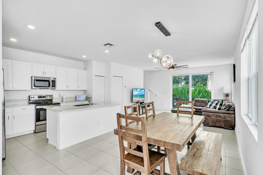 This beautifully appointed TH offers 3-2.5 + den, 1,821 sq ft of living space 2,105 total. A modern, open-concept layout designed for both style and functionality.Featuring a seamless flow between the living room, dining area, and spacious kitchen, perfect for entertaining. The kitchen showcases quartz countertops, a large island, SS appliances, and white shaker cabinetry, all complemented for indoor-outdoor living. A quiet den on the first floor provides the ideal space for a home office or study. The 1-car garage is finished with sleek epoxy flooring for a clean, polished look.Upstairs, you'll find you'll find three serene bedrooms and baths. Residents of Veranda Landing enjoy a pet-friendly community. Minutes from the Turnpike, supermarkets, restaurants, shops, and a new hospital.