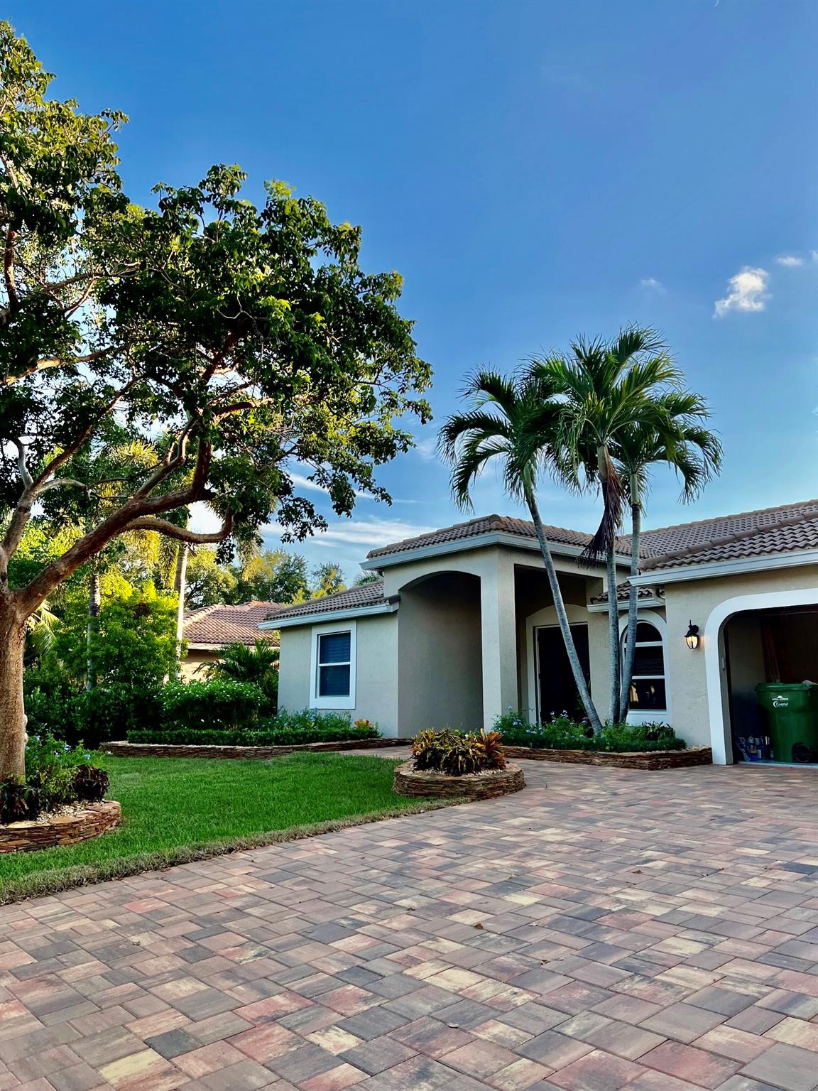 Beautifully upgraded home where the outdoors are just as impressive as the inside. Professionally landscaped with tropical flair, this meticulously maintained Split 5 bedroom 2.5 bath pool home features stunning custom stonework and tropical curb appeal. The seller has spared no expense in creating a beautifully landscaped oasis that makes a lasting first impression. From colorful crotons to hand-stacked stone beds, every detail is designed for beauty and ease of maintenance. New kitchen cabinets & appliances, plantation shutters, IMPACT GLASS windows & doors. tiled floors, solar sun shade. LED lighting, Large Primary Suite, Solar water heater. Low-maintenance rock beds and lush greenery, Perfect blend of design, function, and Florida charm. Great locations. HOA FEES JUST $625 PER YEAR