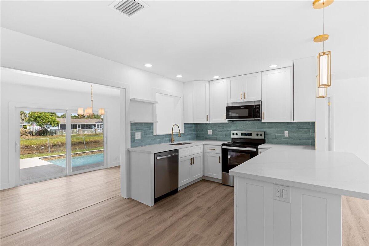 Welcome to this fully renovated (available furnished or unfurnished), pet friendly, 3-bedroom, 2-bathroom waterfront pool home in the heart of Palm Beach Gardens with no HOA, & 6 month minimum lease. FOR SALE AS WELL RX-11101682 Updated in 2025, featuring new electrical panel and rewiring, NEW AC, NEW tankless water heater, NEW washer and dryer. NEW ROOF is in process of being completed. You'll fall in love with the bright and airy new layout including recessed lighting, luxury vinyl plank flooring, and interior/exterior paint. The open concept kitchen includes all new SS appliances, with ample storage and eat in counter space! Pool and lawn maintenance included.