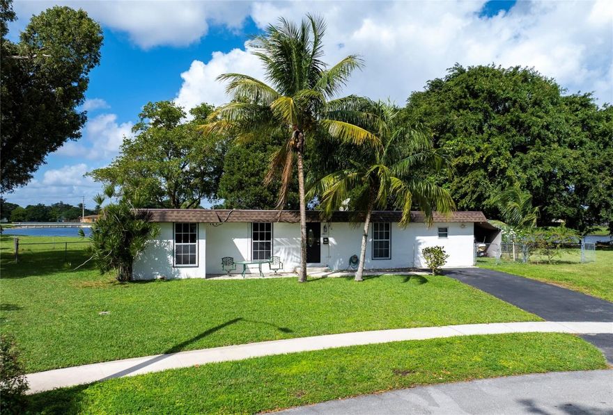 Charming 3-bedroom, 2-bath home with stunning water views and modern upgrades! Set on a rare pie-shaped lot offering privacy, tranquility, and breathtaking sunsets, this home features a spacious backyard with a large patio, stylish gazebo with lights and sound system, jacuzzi, and fire pit. Inside, enjoy a remodeled kitchen, dining room, and bathrooms (2020-2022). Upgrades include a new roof (2021), 2017 A/C with 10-year warranty, updated Samsung appliances, and a 9-camera security system with remote access. The enclosed carport/workshop with A/C offers boat or vehicle storage. The lot backs onto common grounds and a small lake, with no rear neighbors. Located in a quiet, family-friendly neighborhood with low HOA fees, excellent schools, community pool, playgrounds, and sports courts.